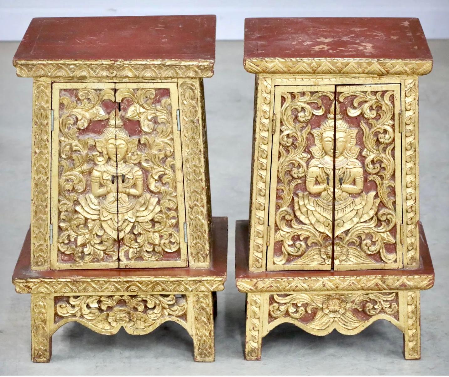 Pair of Southeast Asian carved polychrome painted and giltwood pedestal cabinets. Beautiful red and gold in color. Inside of cabinets are two shelves and all interior is painted red.   Great size that will fit in any room. 