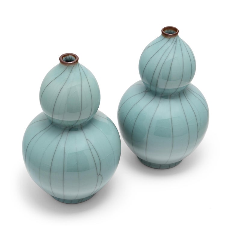 The graceful, hourglass form of these contemporary vases dates back as far as the Song dynasty (960 to 1279). Known as huluping or double gourd vases, the traditional form emulates the shape of calabashes, or bottle gourds, symbols of health,