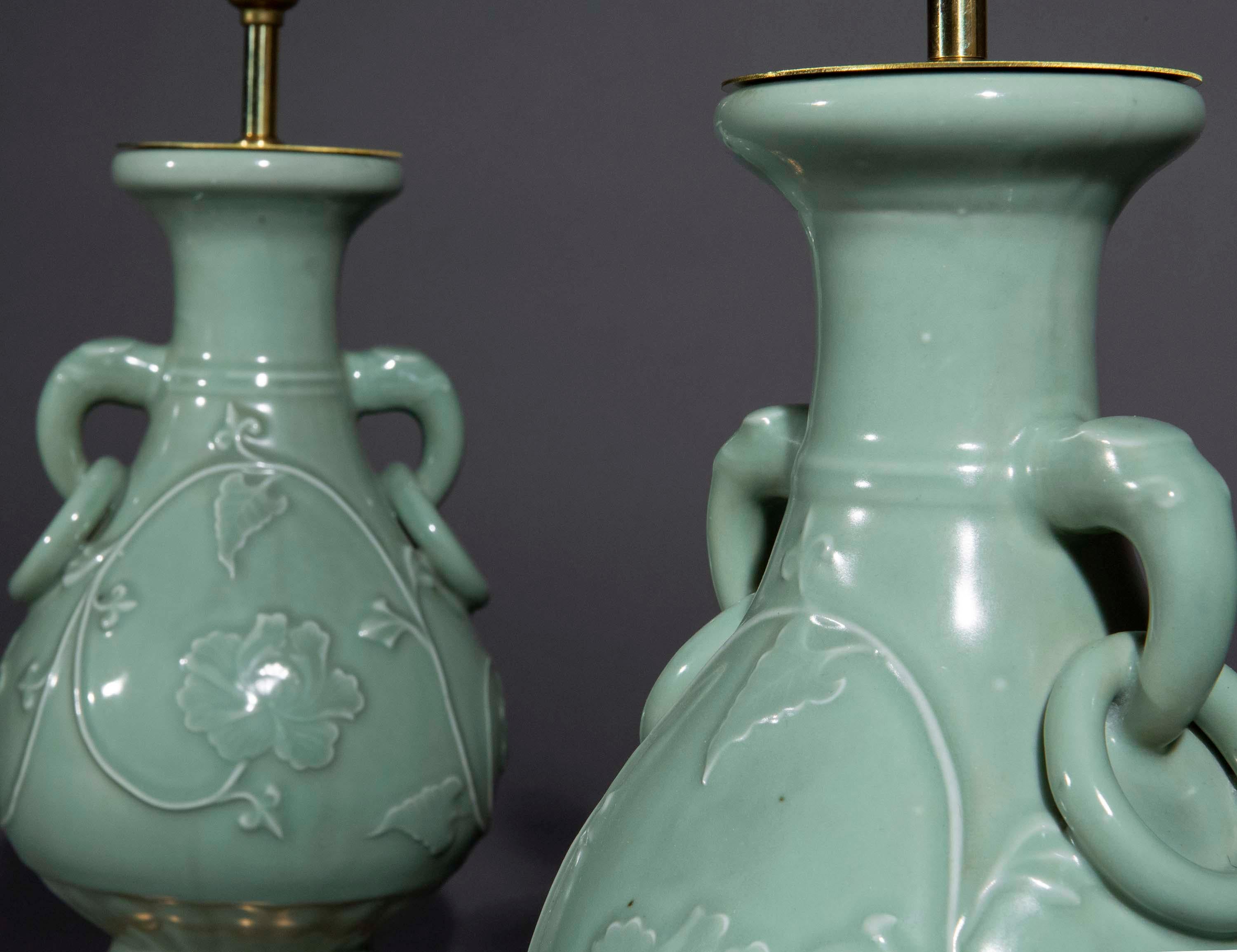 A pair of Chinese Longquan ware vases in light-green celadon glaze, of the 12th–14th century Song or Yuan dynasty style. Fitted as lamps on gilt turned circular bases.
Vases China, early to mid-20th century.

The vases have the