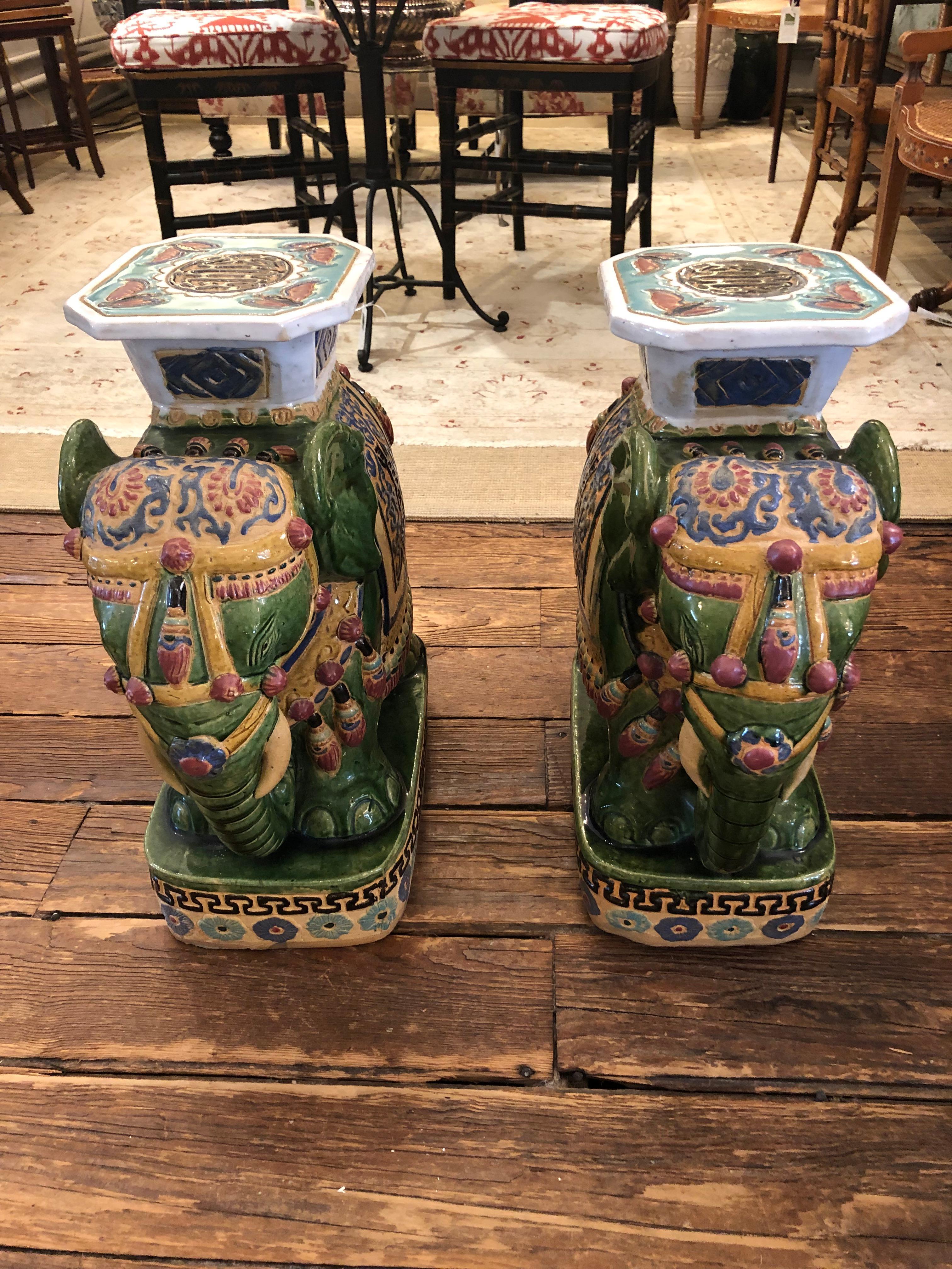 Gorgeous rare pair of vintage ceramic elephant form garden seat tables in marvelous colors including moss green, prussian blue, beige, mauve and turquoise.  Surface on top 9.25 x 7.75