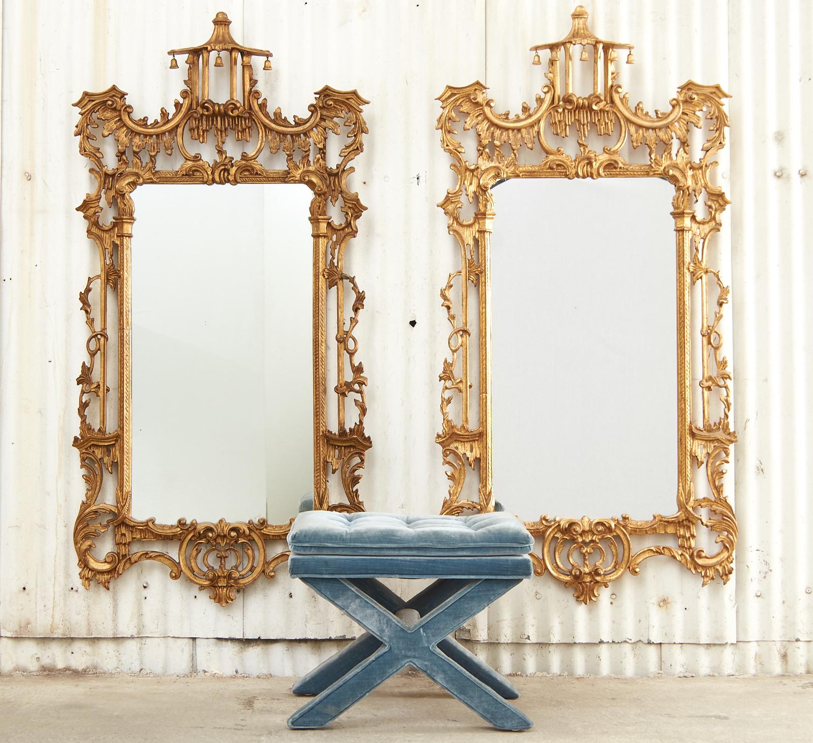 Opulent pair of matching Chinese Chippendale pagoda mirrors having two finishes. Made in Italy and finished in gilt and the other in bronze. The mirrors feature a highly carved frame decorated with C scrolls, acanthus, and climbing vines. Surmounted