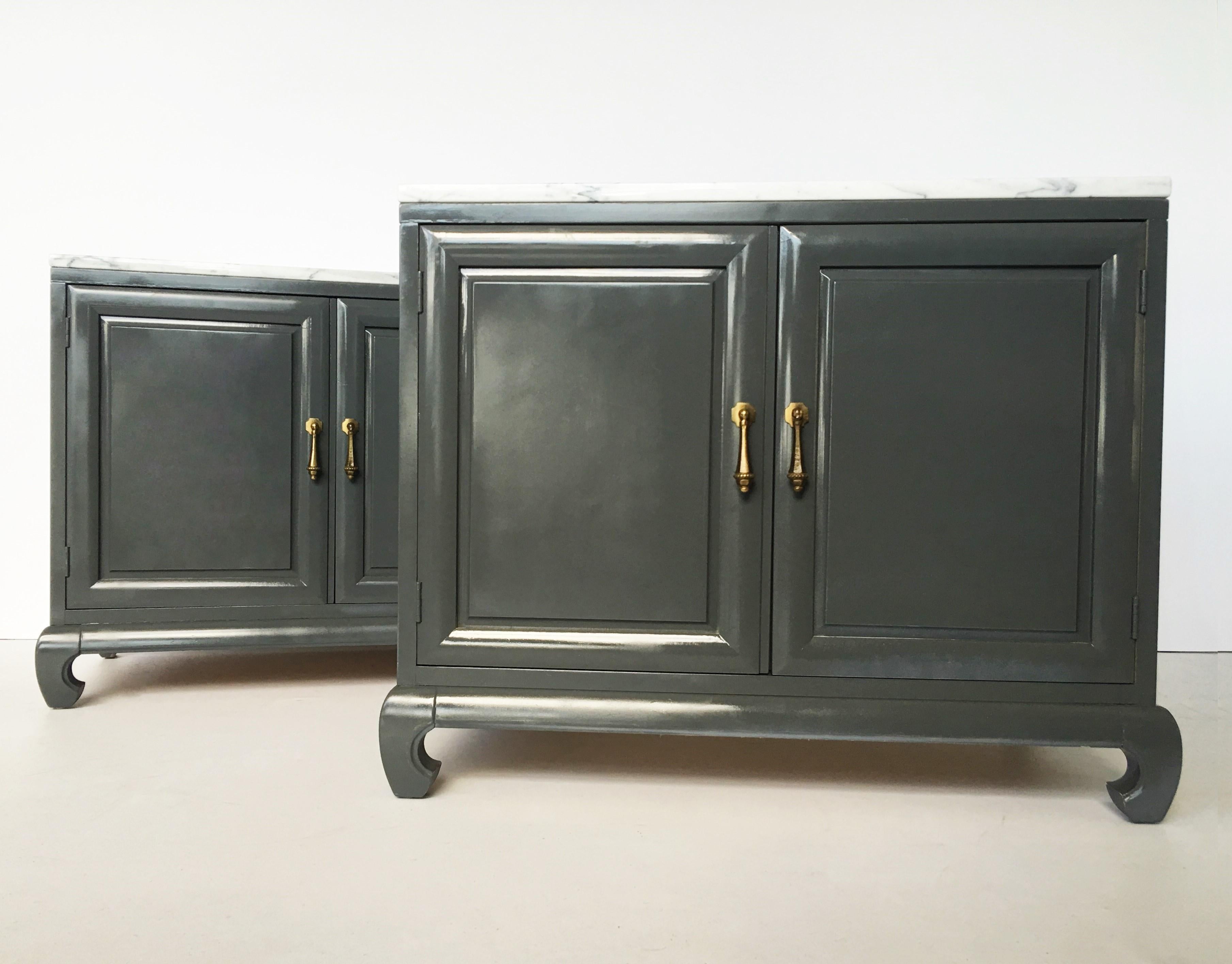 Pair of stunning James Mont style lacquer Asian Modern chinoiserie Ming nightstands. Made of wood and lacquered in a dark silver-gray tone with marble tops. Each cabinet has two doors in the front with original brass Asian pulls, Ming style turned
