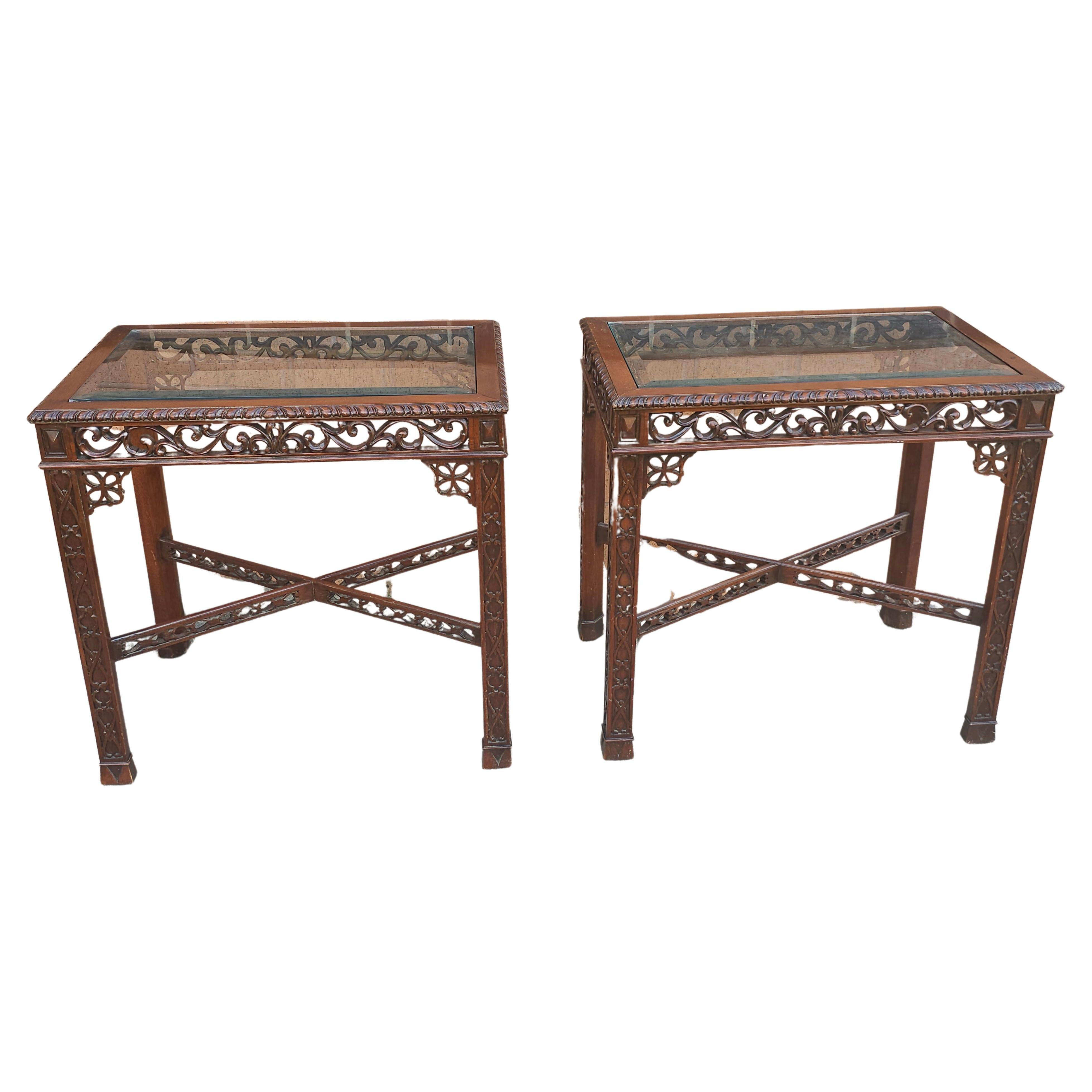 A Pair Of Chinese Chippendale Style with a mixture of transparent and blind fretworks throughout and beveled Glass Inset Mahogany Side Tables. Measure 18.5