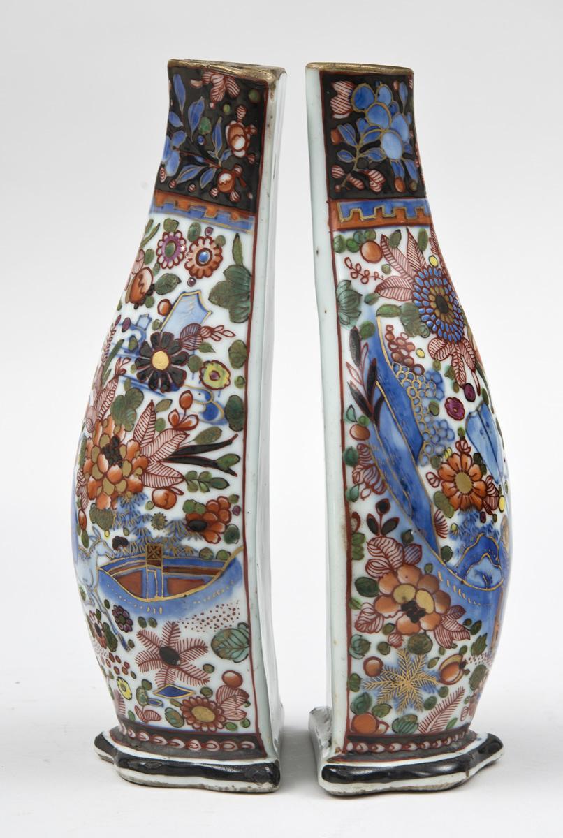 Very finely decorated and colorful pair of Chinese wall pockets with flat backs, the body depicting a figure with a servant and a horse in the background amid flowers and mountains.

During the 18th and early 19th century, often blue and white