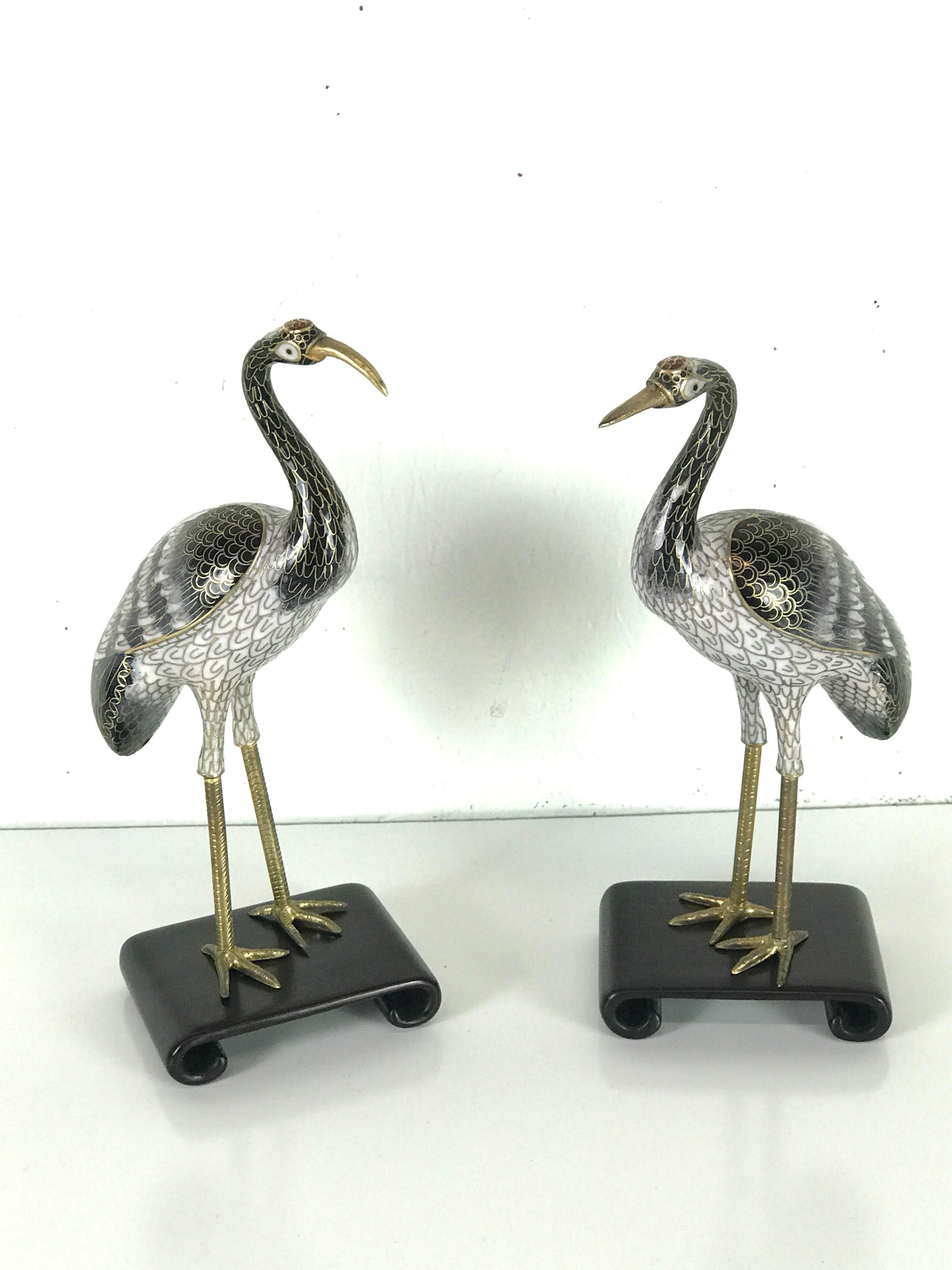 Pair of Chinese cloisonné cranes, each one standing on carved hardwood Stand, Beautiful quality, unsigned.
Measure: Each crane stands 9.5