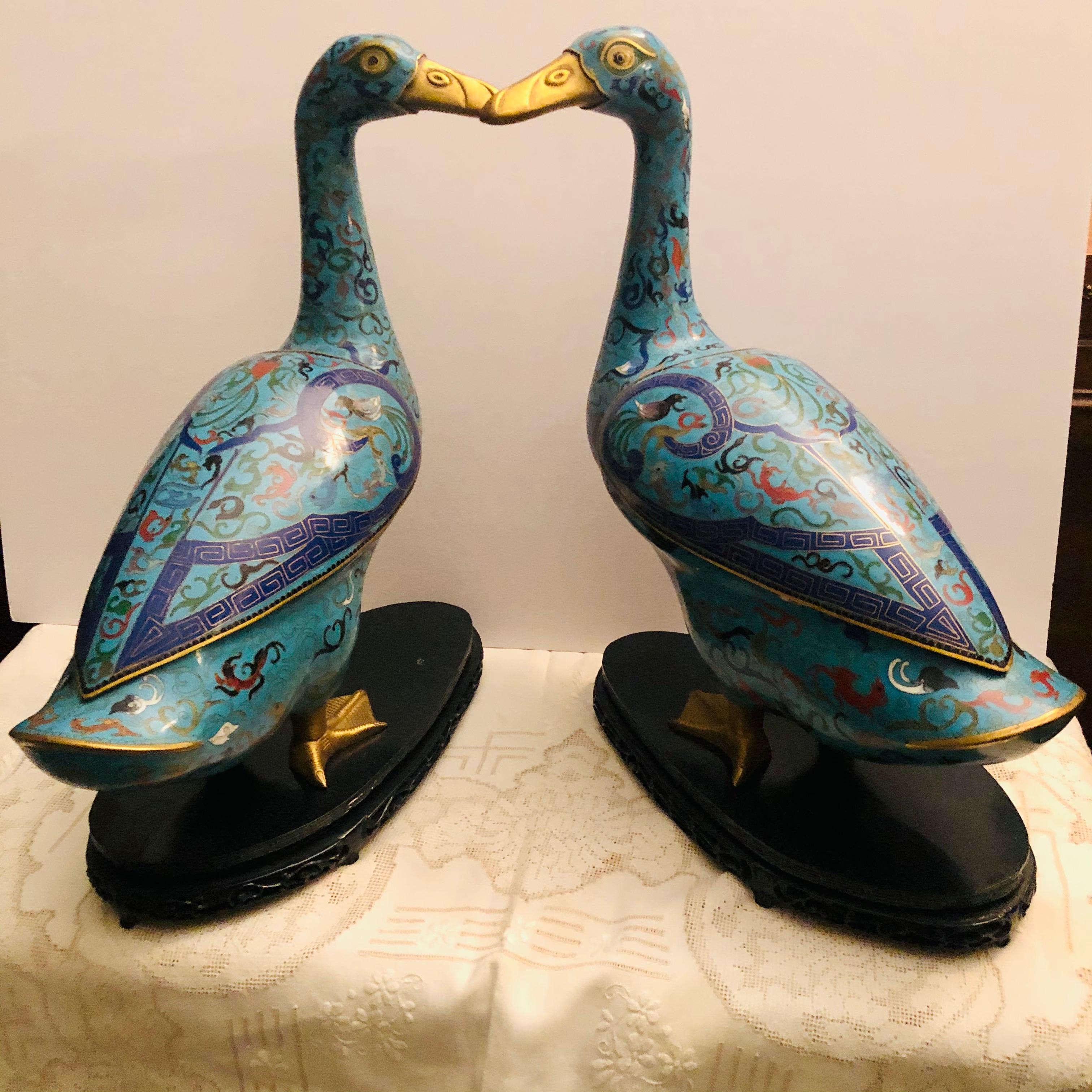 This is a pair of Chinese cloisonné enamel ducks. These ducks have removable wings, so that the duck bodies can be used as censors or incense burners, or you can use these ducks to store items. They also would be an object of art in your home, as