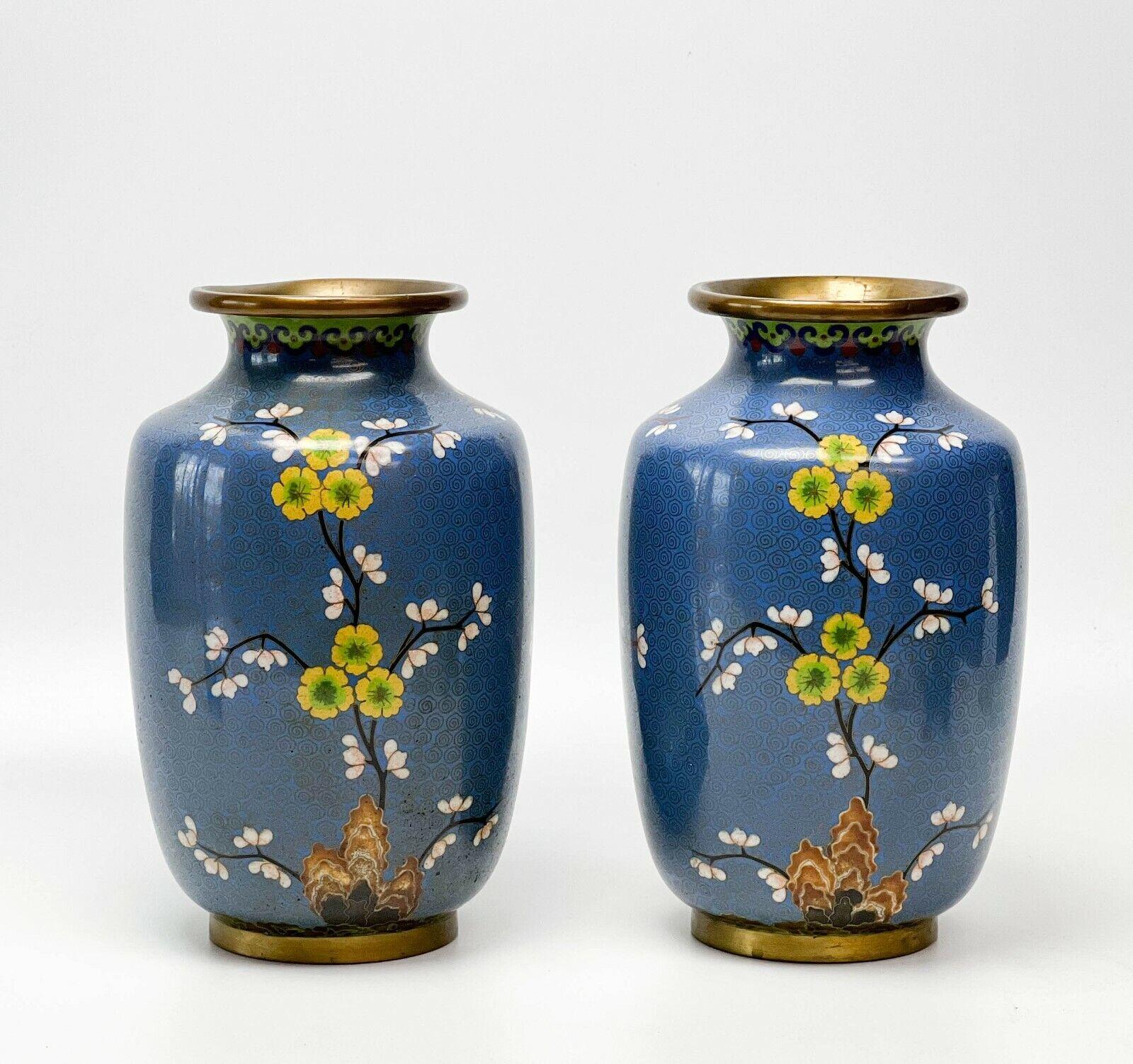 Pair of Chinese Cloisonne Enamel Enamel and bronze mounted vases penny Marshall

A blue ground with colorful cherry blossoms to the base of each vase with a pattern of swirls to the ground. Apparently unmarked. From the estate of Penny Marshall,