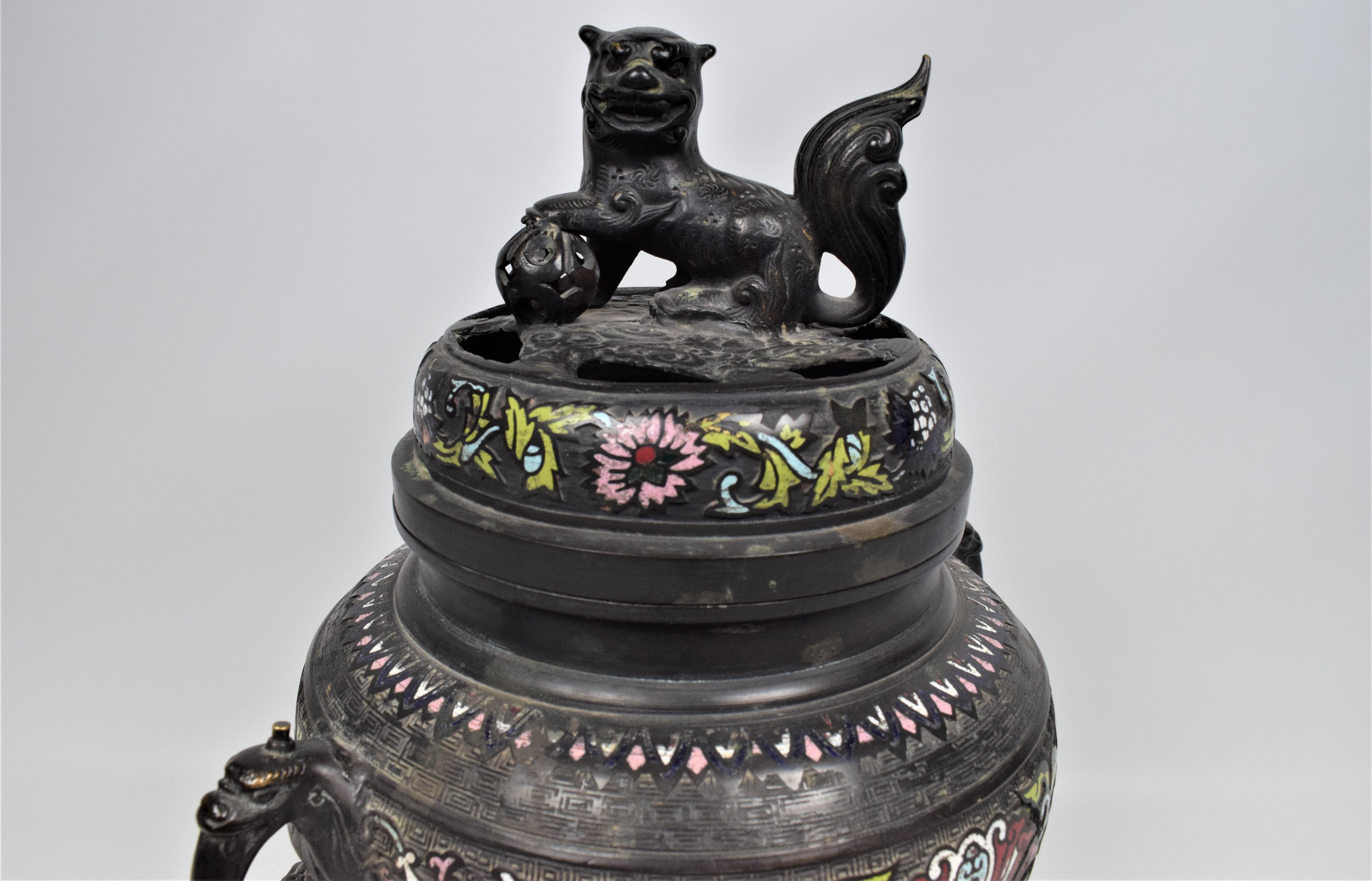 This magnificent pair of 19th-century Chinese gilt cloisonné bronze incense burners is a testament to the artistry and craftsmanship of the period. Each burner, standing on an ornate base, is elevated by intricately detailed dragons, their sinuous