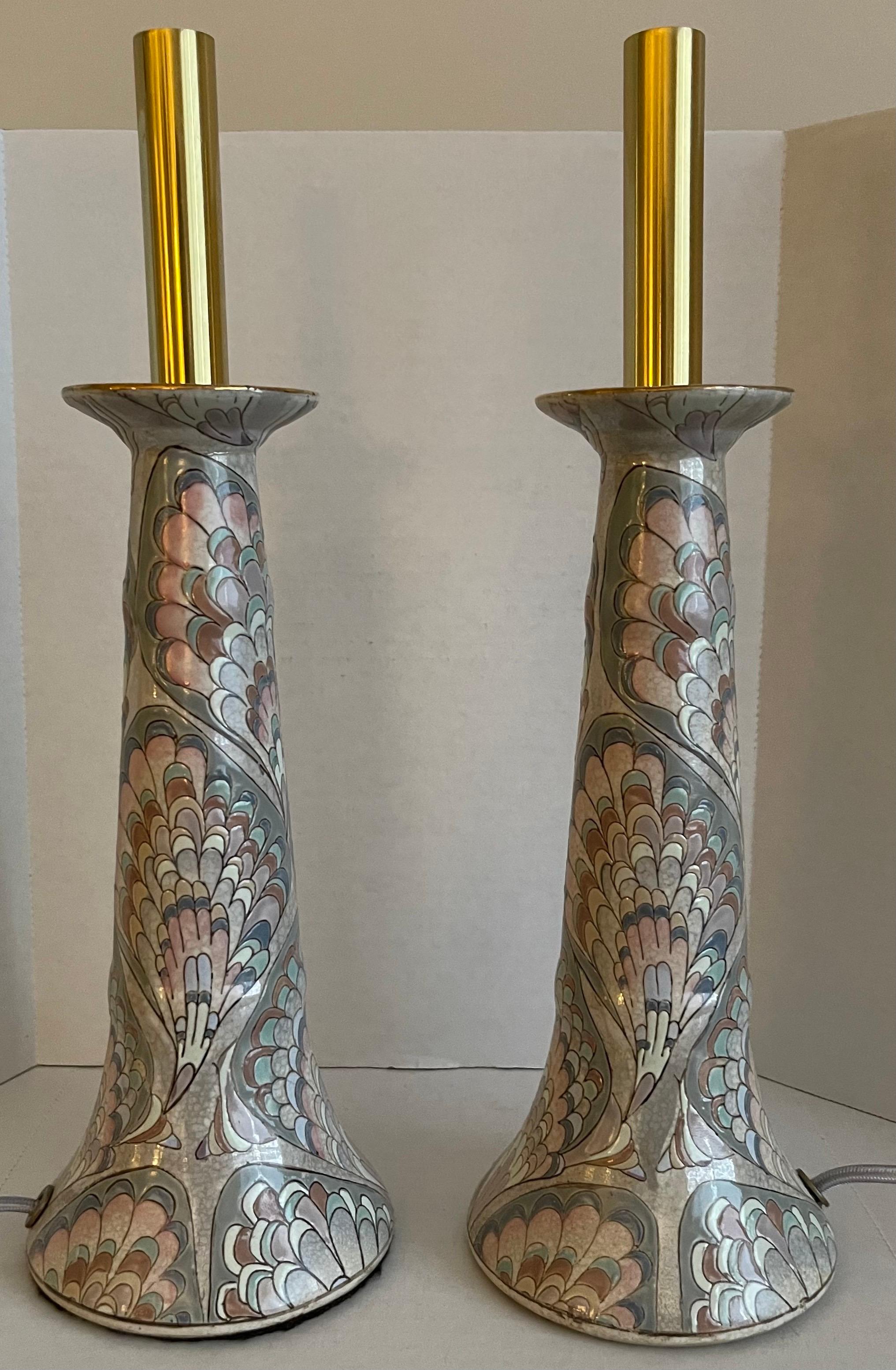 Pair of cloisonné candlestick lamps. Light purple marbleized peacock feather design. Newly fitted with brass candlestick fittings and grey silk cords with side switches. 
Each lamp takes one candelabra bulb (45 watt max).
Lampshades not included.