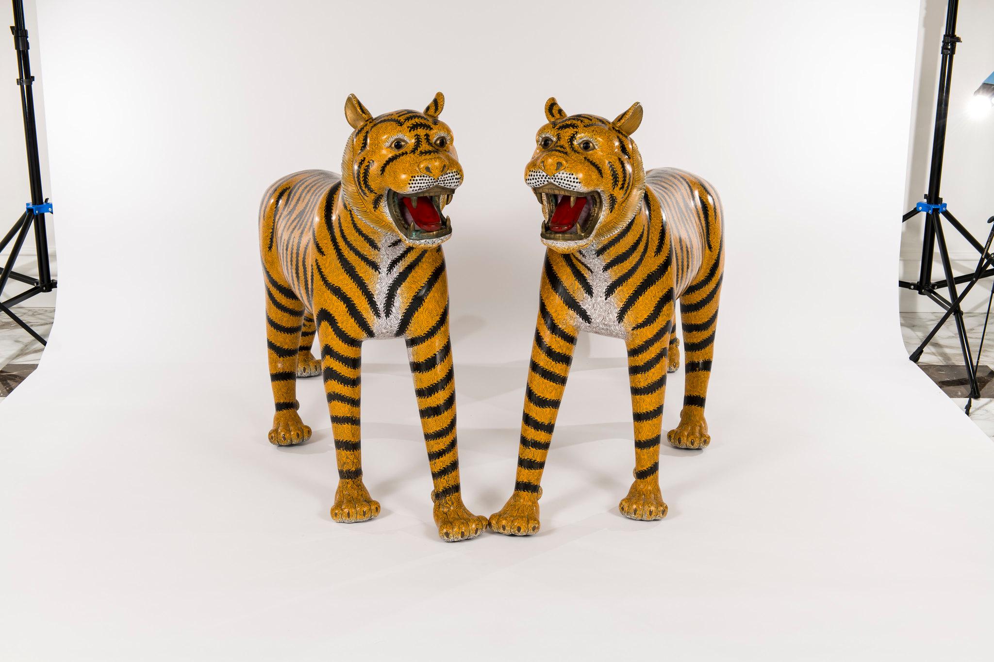 A stunning pair of late 20th century life-size Chinese cloisonné tigers from the Baron Estate. 

In Chinese symbolism, these tigers represents the masculine principle in nature and is king of all the animals, as shown by the four stripes on his