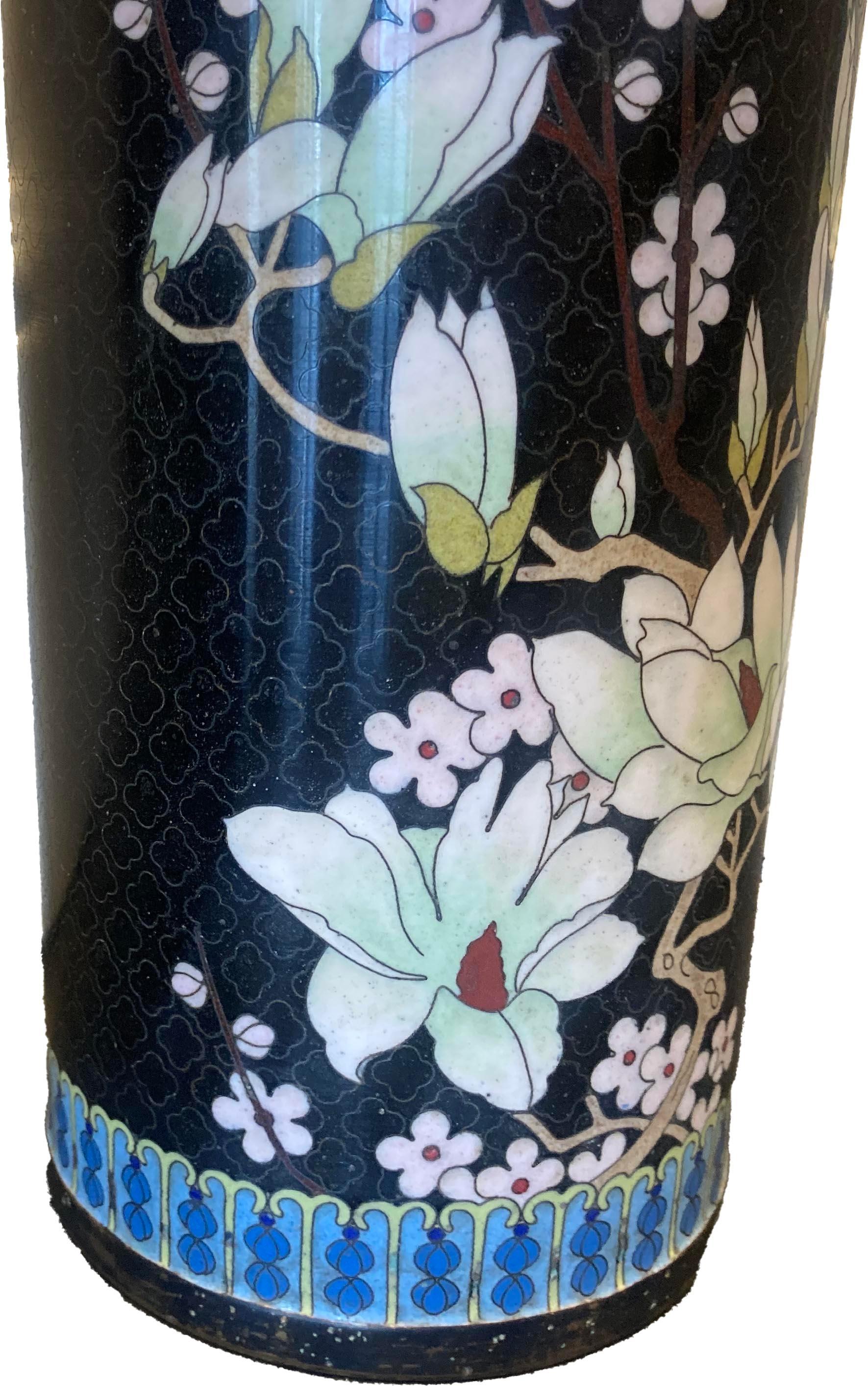 Pair of unique black chinese Cloisonné vases with floral design and traditional ruyi decorative border at the top. Blue enamel interior.