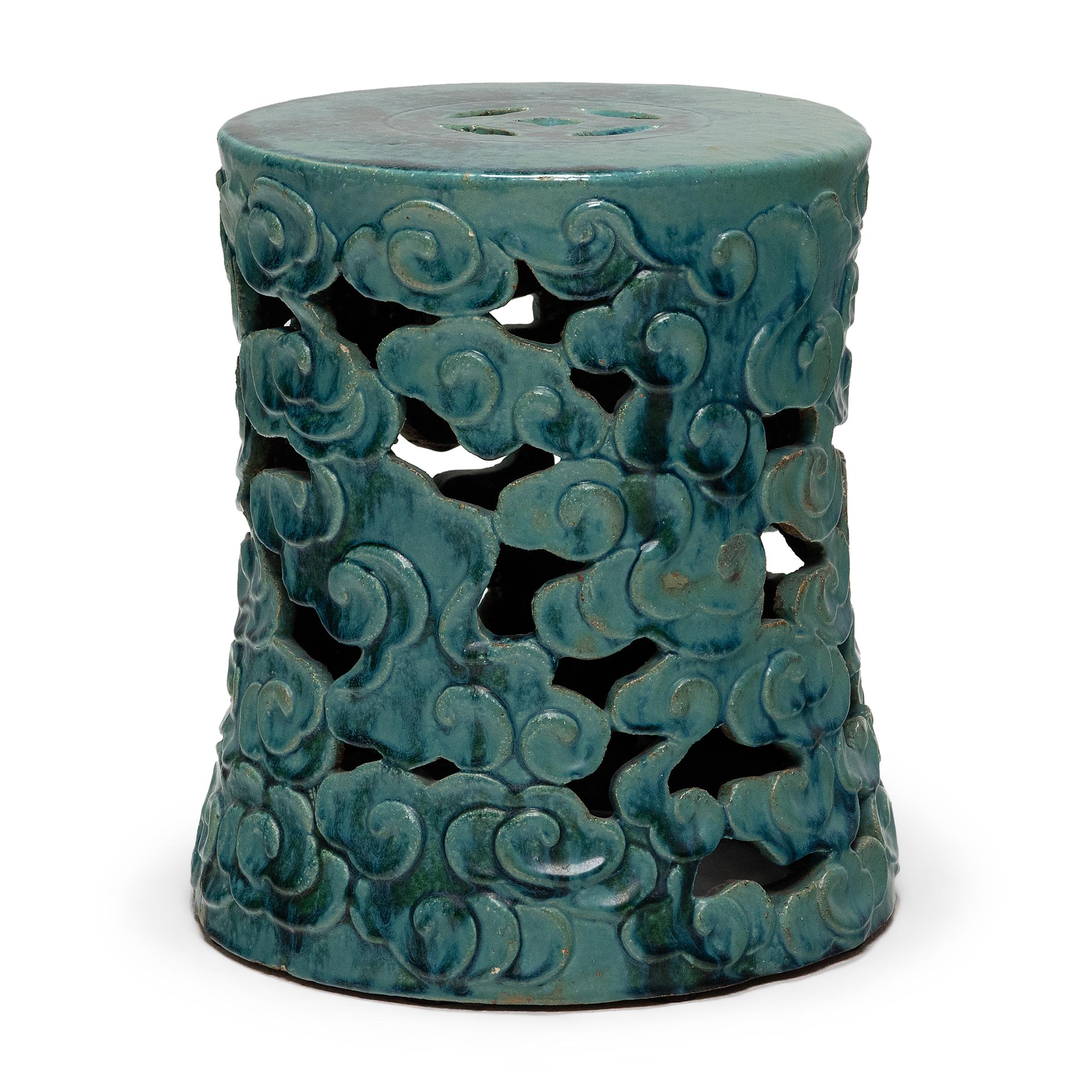 These drum-form garden seats were a fixture of the Qing dynasty garden, used as a multipurpose space to rest one's feet or serve tea. These ceramic garden stools feature convex sides encircled by billowing clouds enveloped in a vibrant turquoise