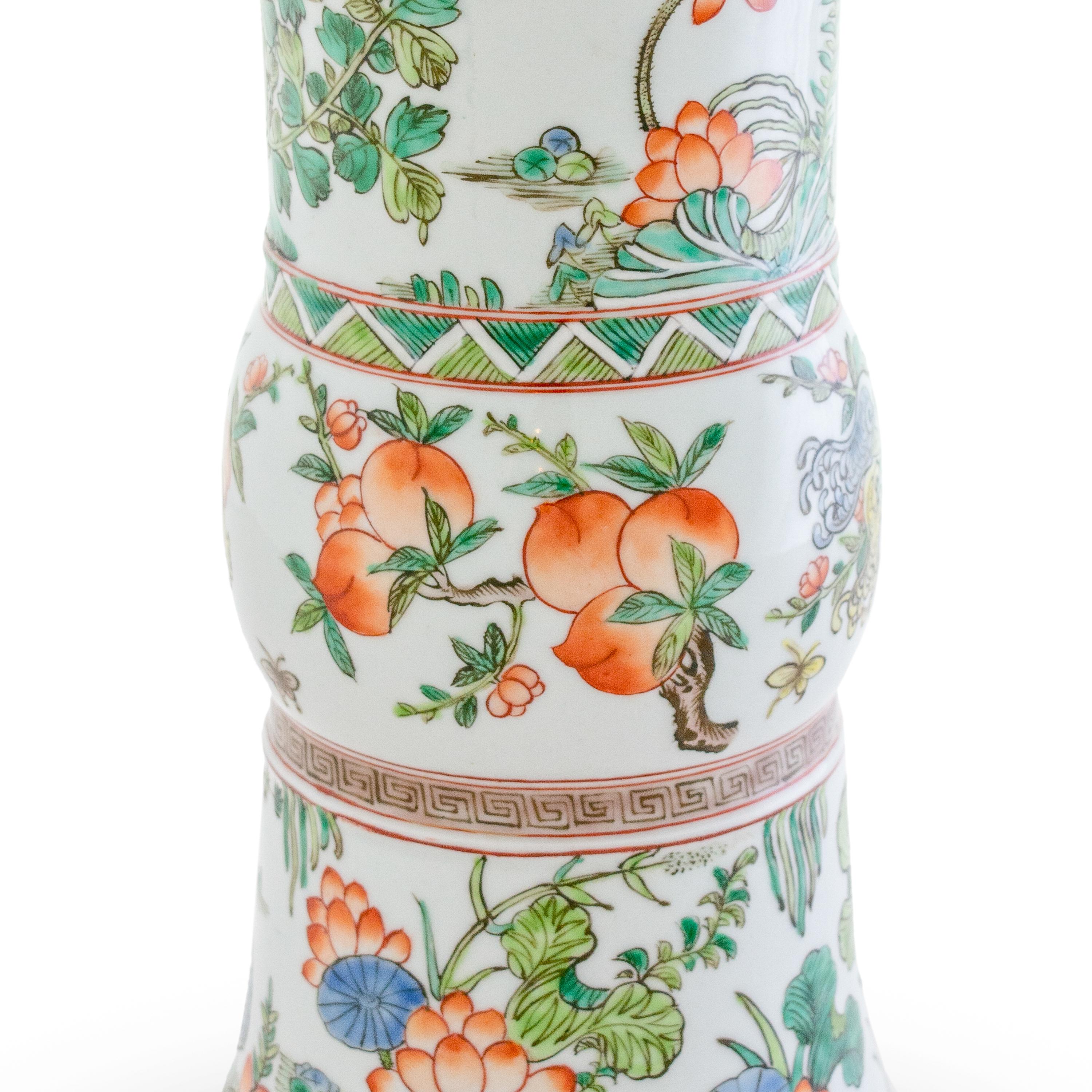 This is a beautiful pair of Chinese trumpet vases, hand-painted in a delicate pallet, depicting colorful birds, flowers and foliage.