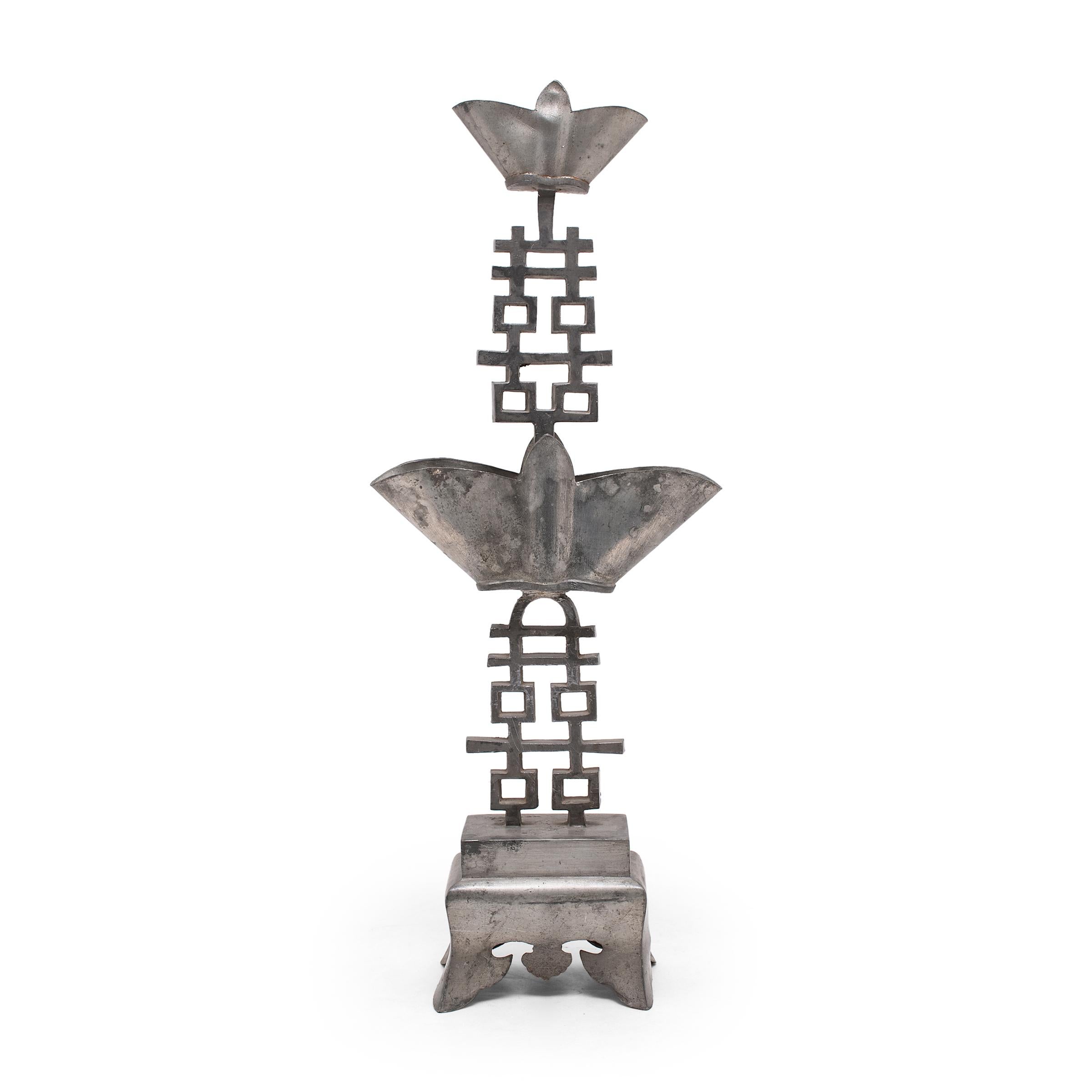 These early 20th Century pewter candle stands convey blessings of joy and good fortune. The stem of each stand is shaped as the ? symbol for 