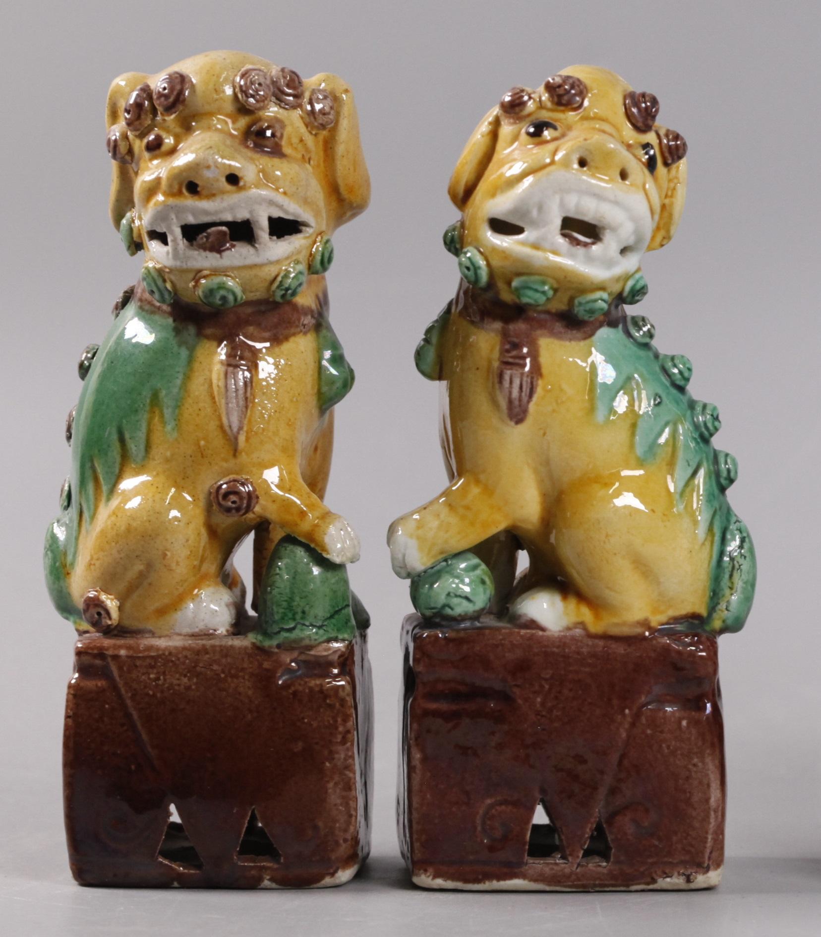 1.6in(D) x 2.8in(W) x 5.8in(H) are the dimensions of the taller foo lion/dog; the paw of one lion is resting on a rock; the paw of the other lion is resting on a ball