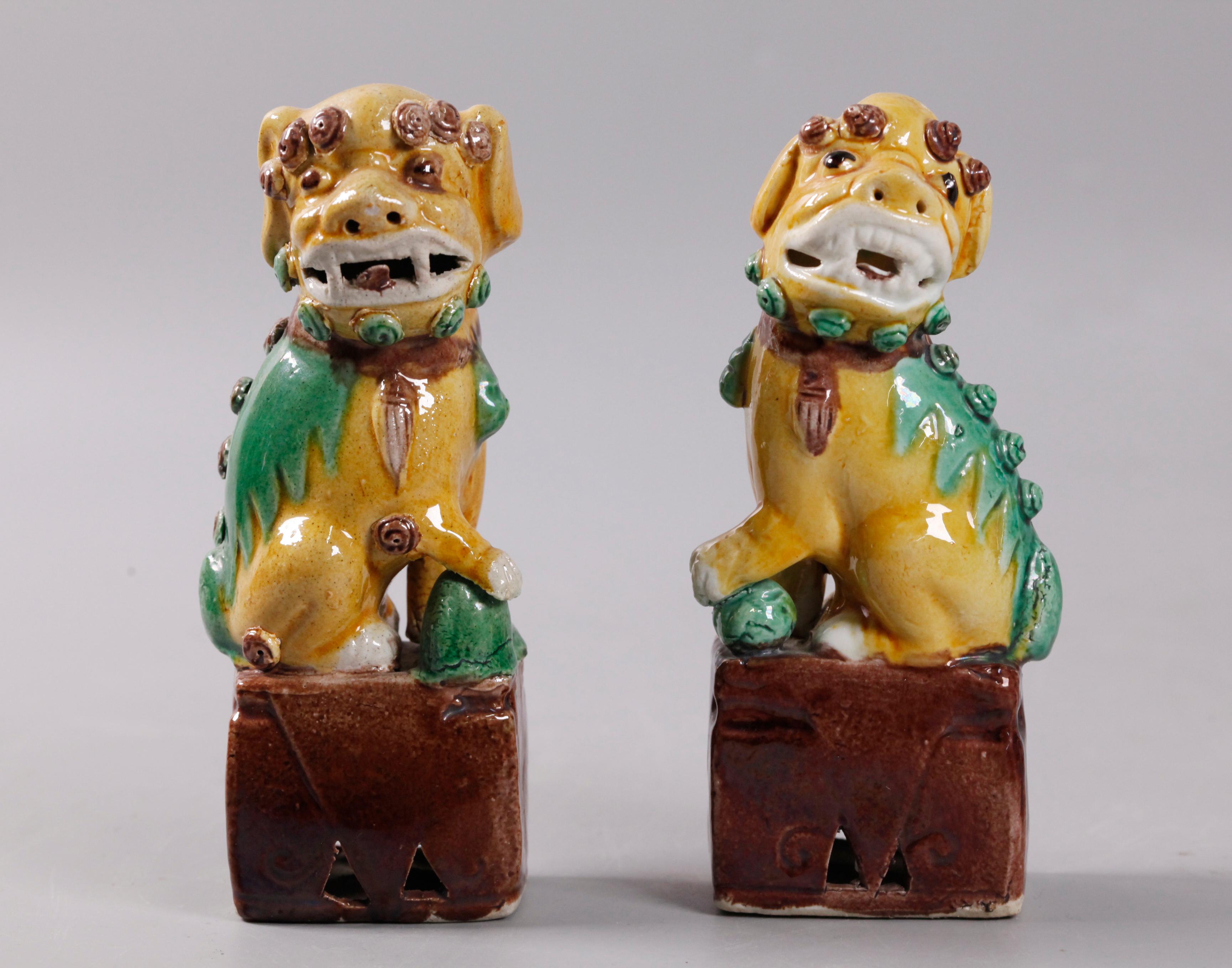 Porcelain pair of Chinese egg, spinach glazed foo lions/dogs, 19th c. For Sale