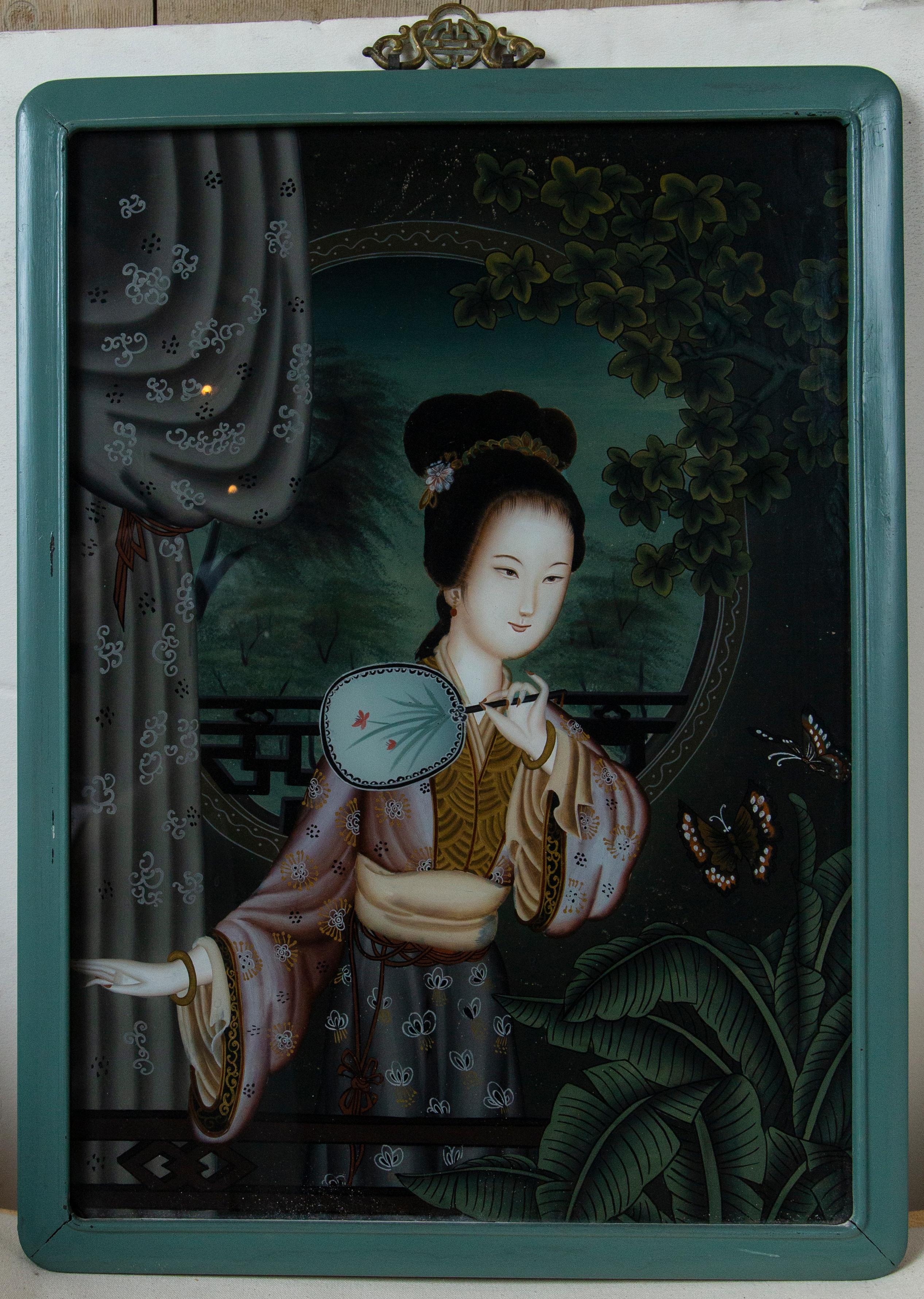 Two beautiful young ladies in traditional dress in reverse paintings on glass. They are set within woodeb frames of robn's egg blue, in the Chinese manner.