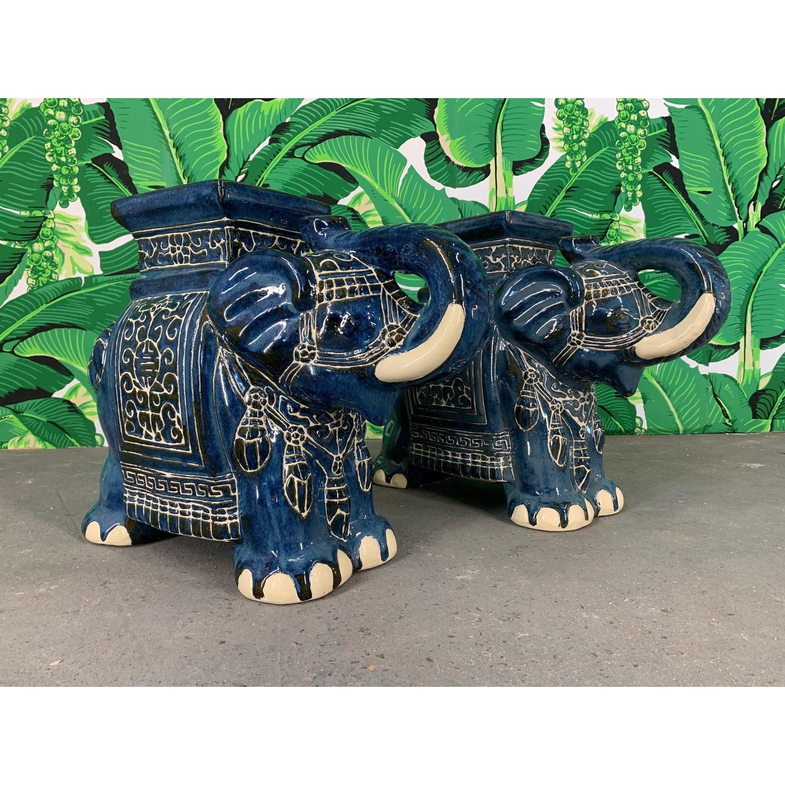 Pair of ceramic elephant garden stools, could be used as end tables, with trunks up (good luck!). Beautiful cobalt blue with glossy glaze. Very good condition overall.