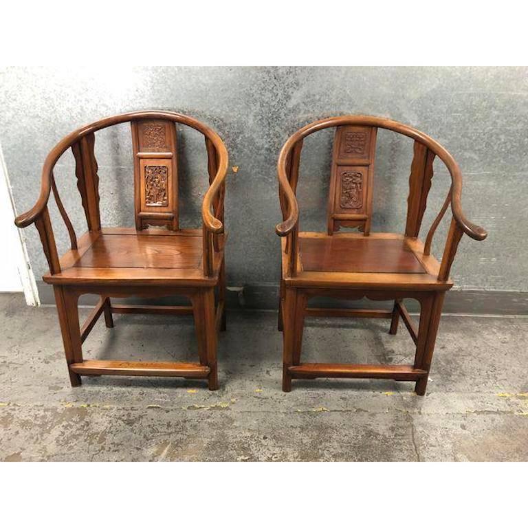 A pair of beautiful side chairs. The chairs are believed to be from The Republic period. They were rendered in solid Elm wood. The chairs are impeccably made and have stunning carving on the backs. They have a very elegant sensibility. Measures: Arm