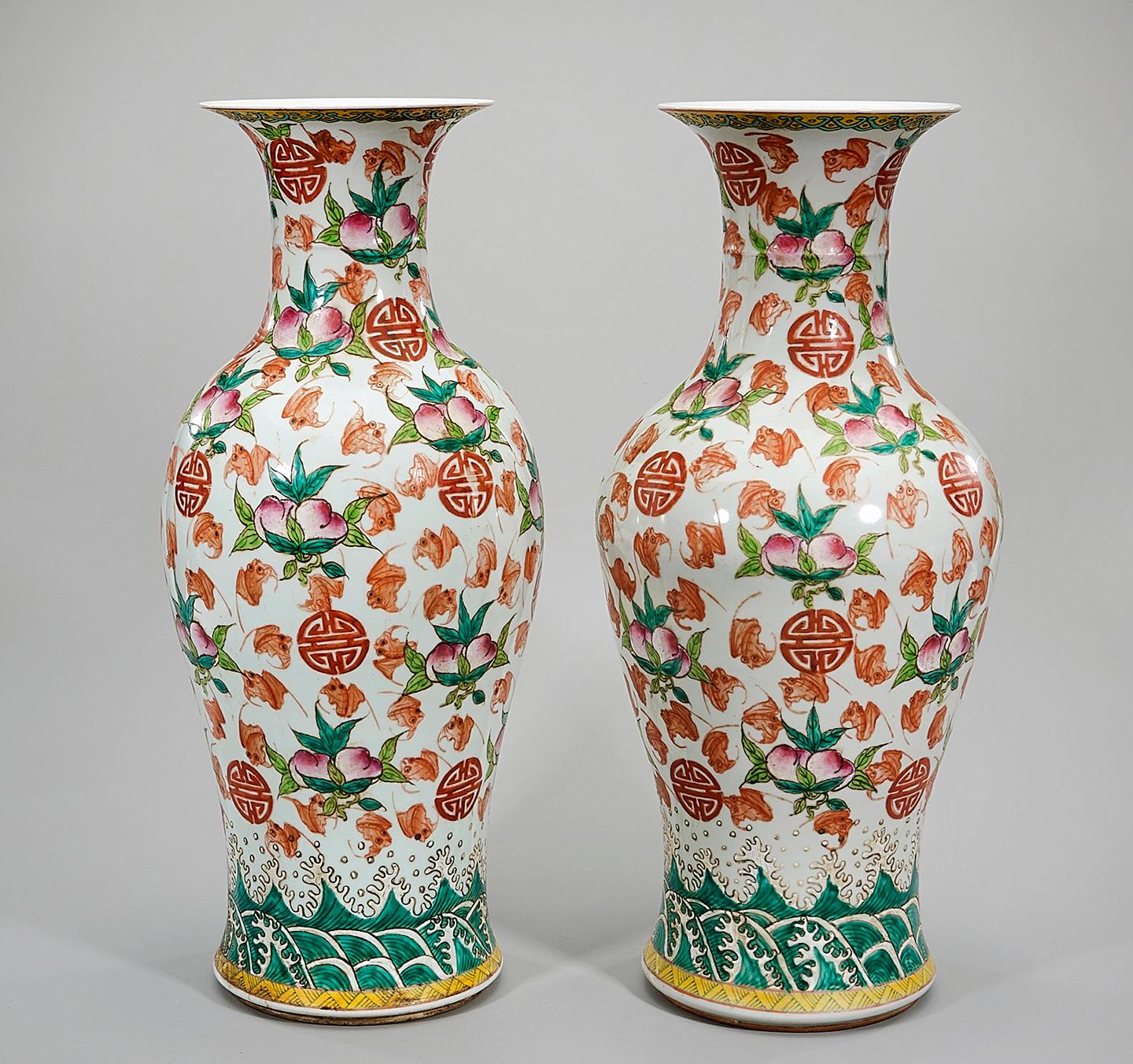 Lovely Pair of Chinese polychrome enameled procelain vases decorated in a foliate and peach motif. 
Shou characters throughout the vase. 
Bearing an under glazed six character markings on the bottom

Measures: H. 23