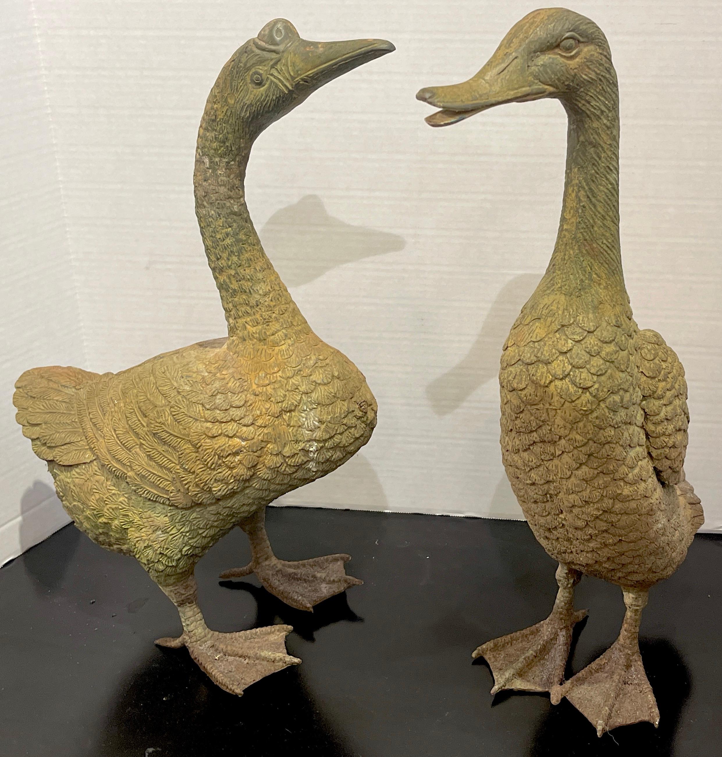 Pair of Chinese Export bronze ducks, Realistically cast and modeled, both with beautiful verdigris patina. One sculpture is slightly taller. Unmarked. Can be used indoors or outdoors 
Measures: Large duck 15