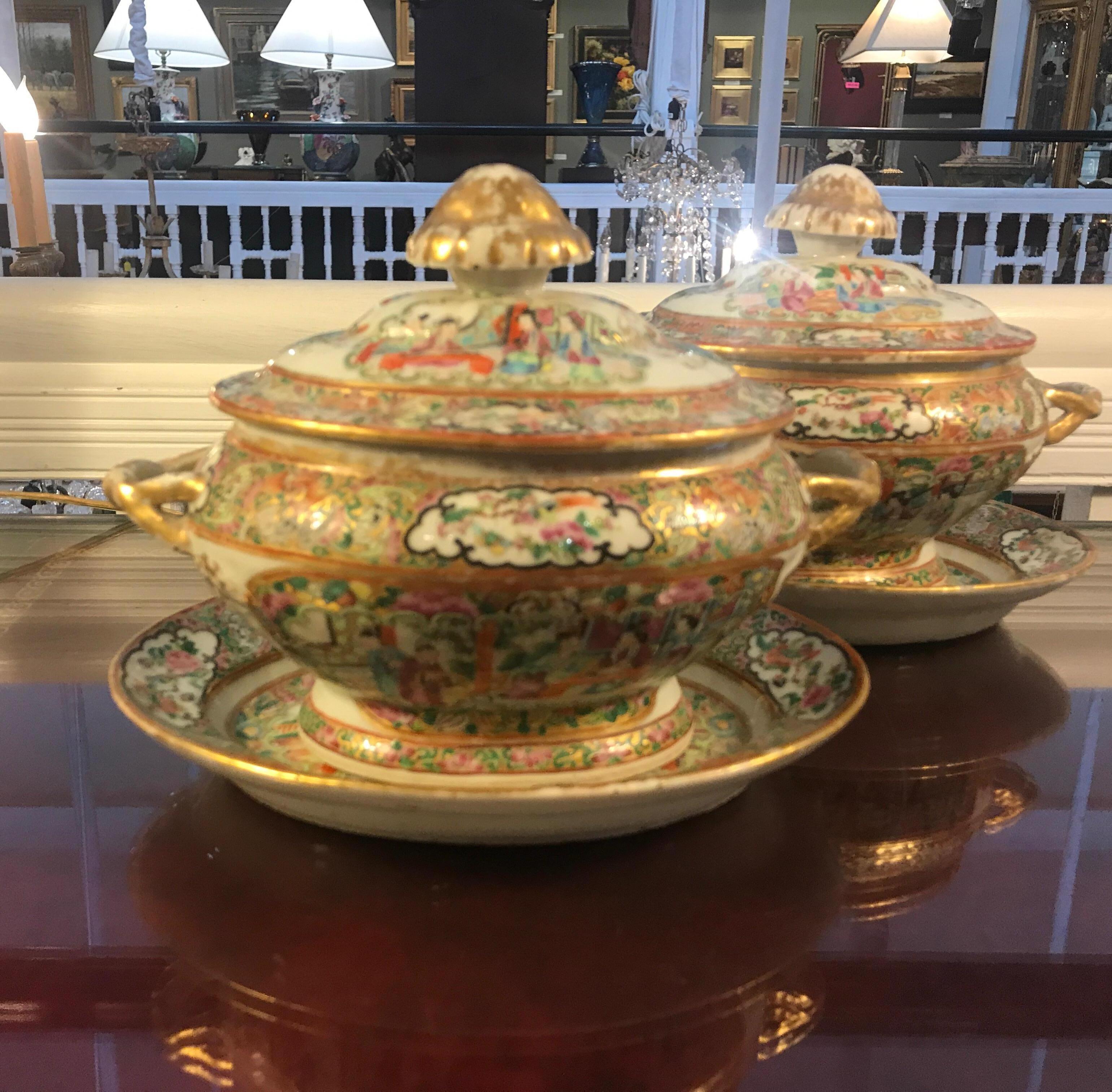 A pair of Chinese export porcelain hand painted rose medallion sauce tureens with under plates. The classic rose medallion pattern with vibrant color and white porcelain background. Both with original lids and plates. The gilt on the handles and lid