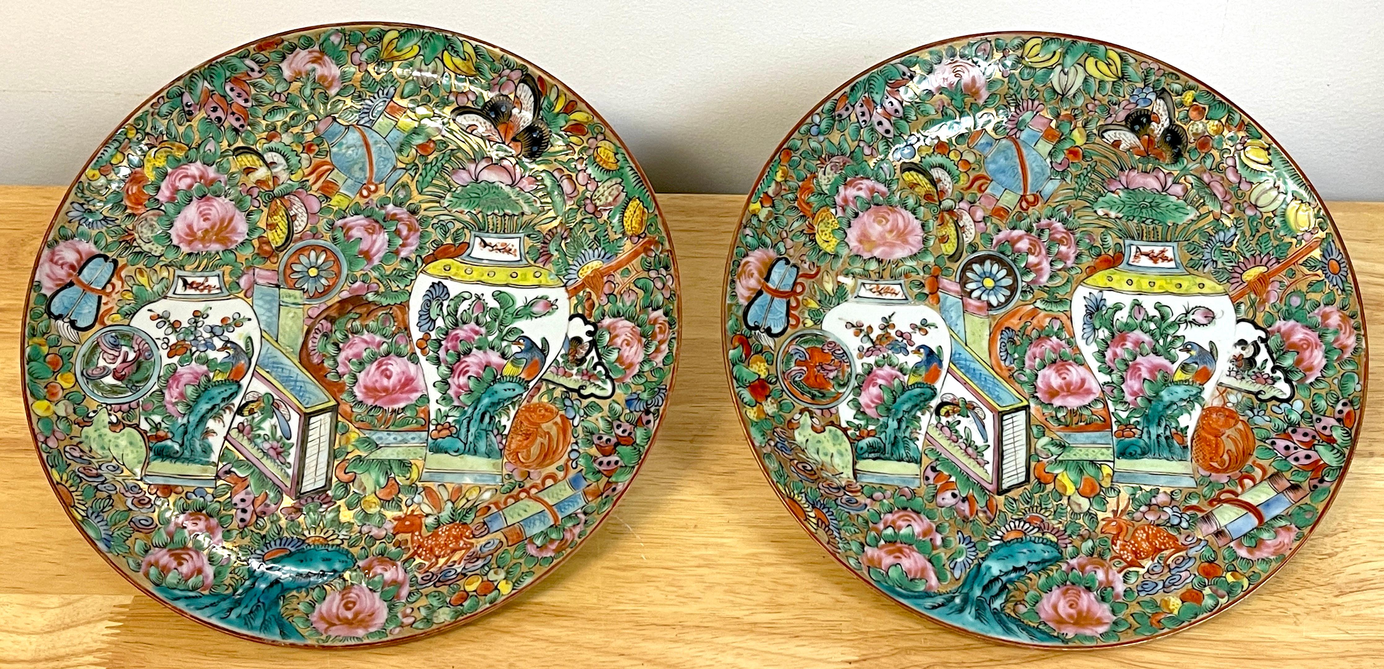 Pair of Chinese Export Famille Rose Urn & Garden Motif Plates, Each plate profusely decorated with two urns amongst a garden with scholars objects.
       