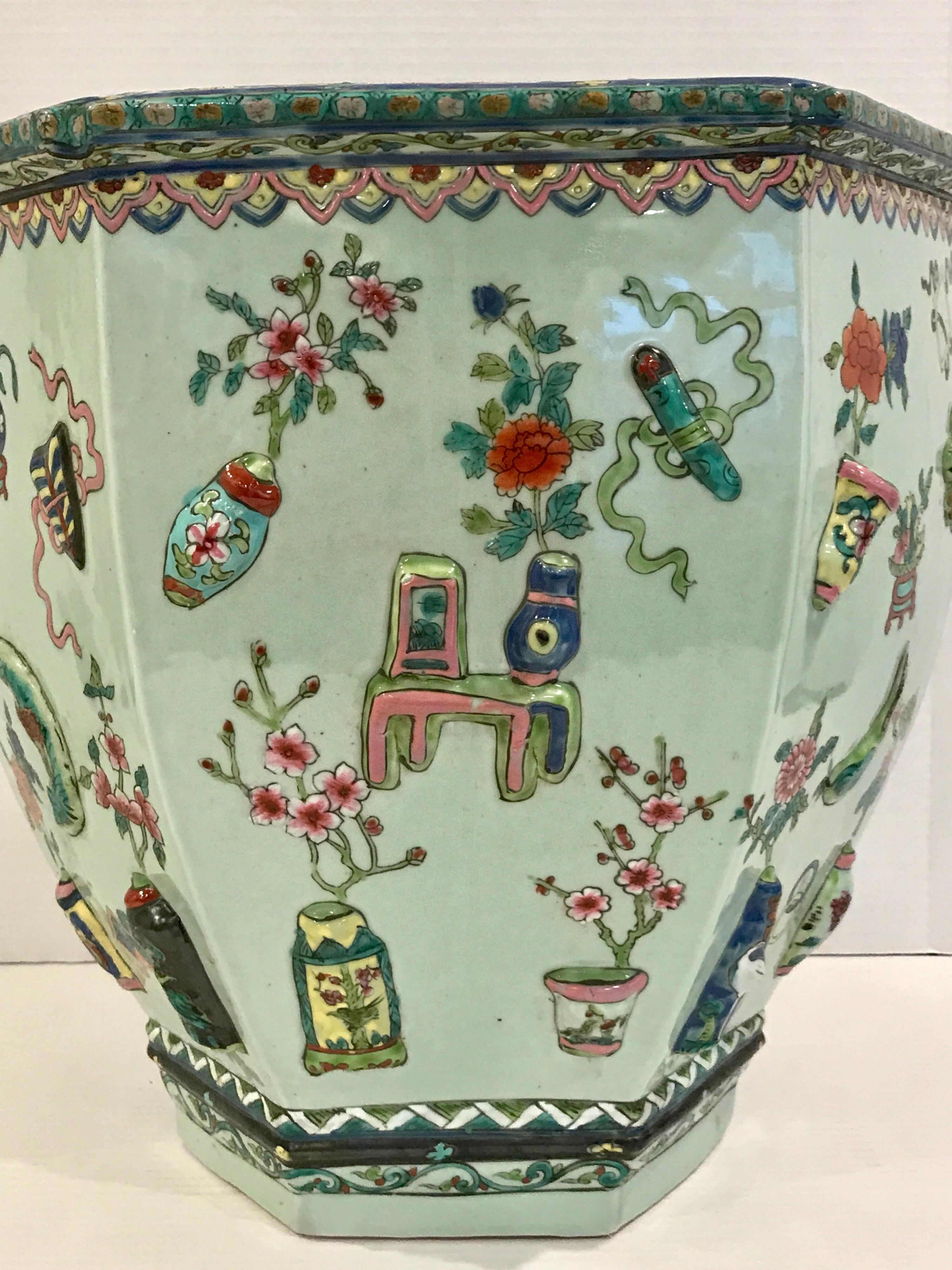 Pair of Chinese export Famille Verte hundred antiques hexagonal jardinières, each one with typical applied decoration, finely painted, with apocryphal reign marks on the 9