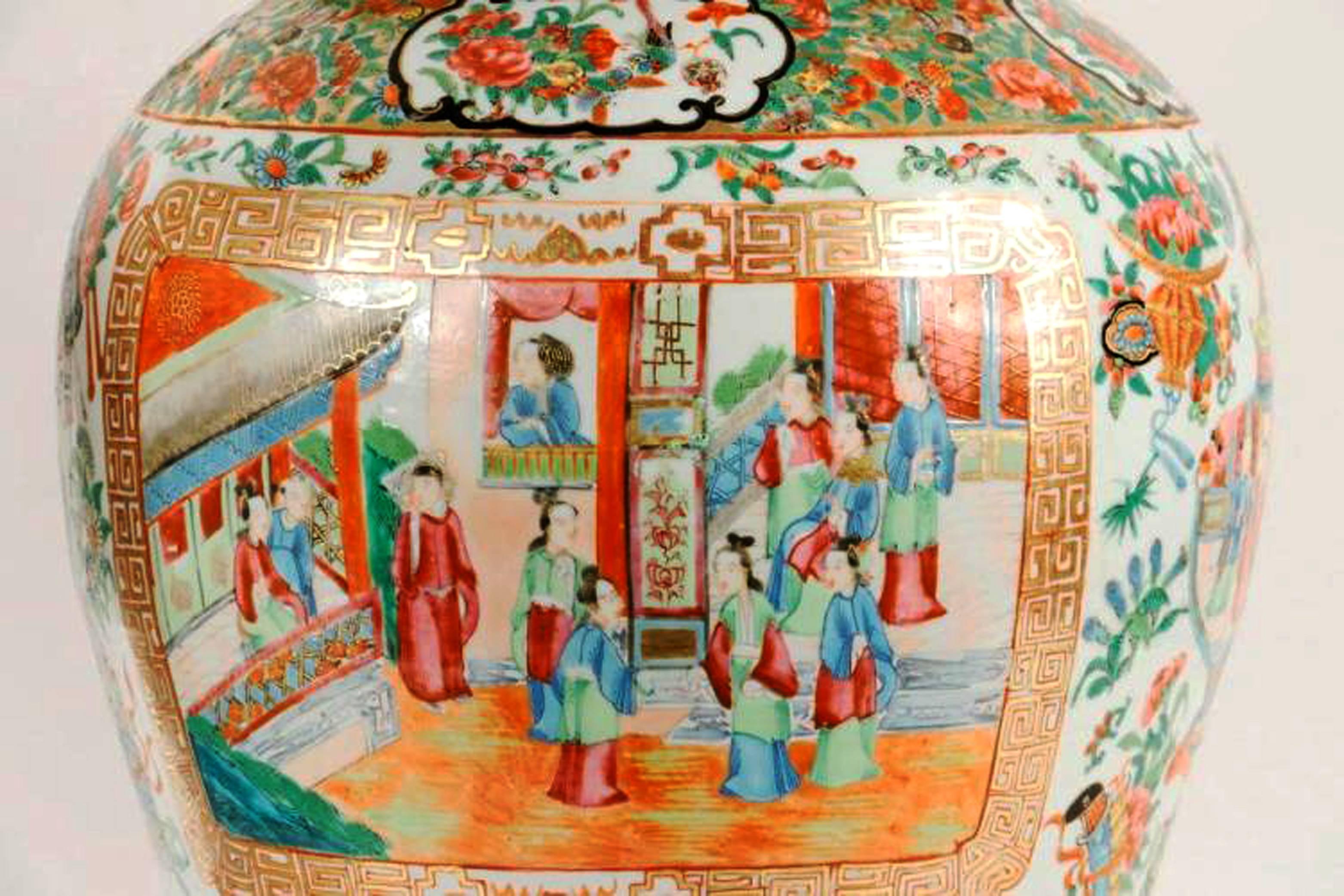 Pair of Chinese export porcelain canton vases and covers,
circa 1840.

The Chinese export porcelain cylindrical vases or urns and covers are decorated with enamelled figural court scenes in panels surrounded by flowers, scholar tools, and