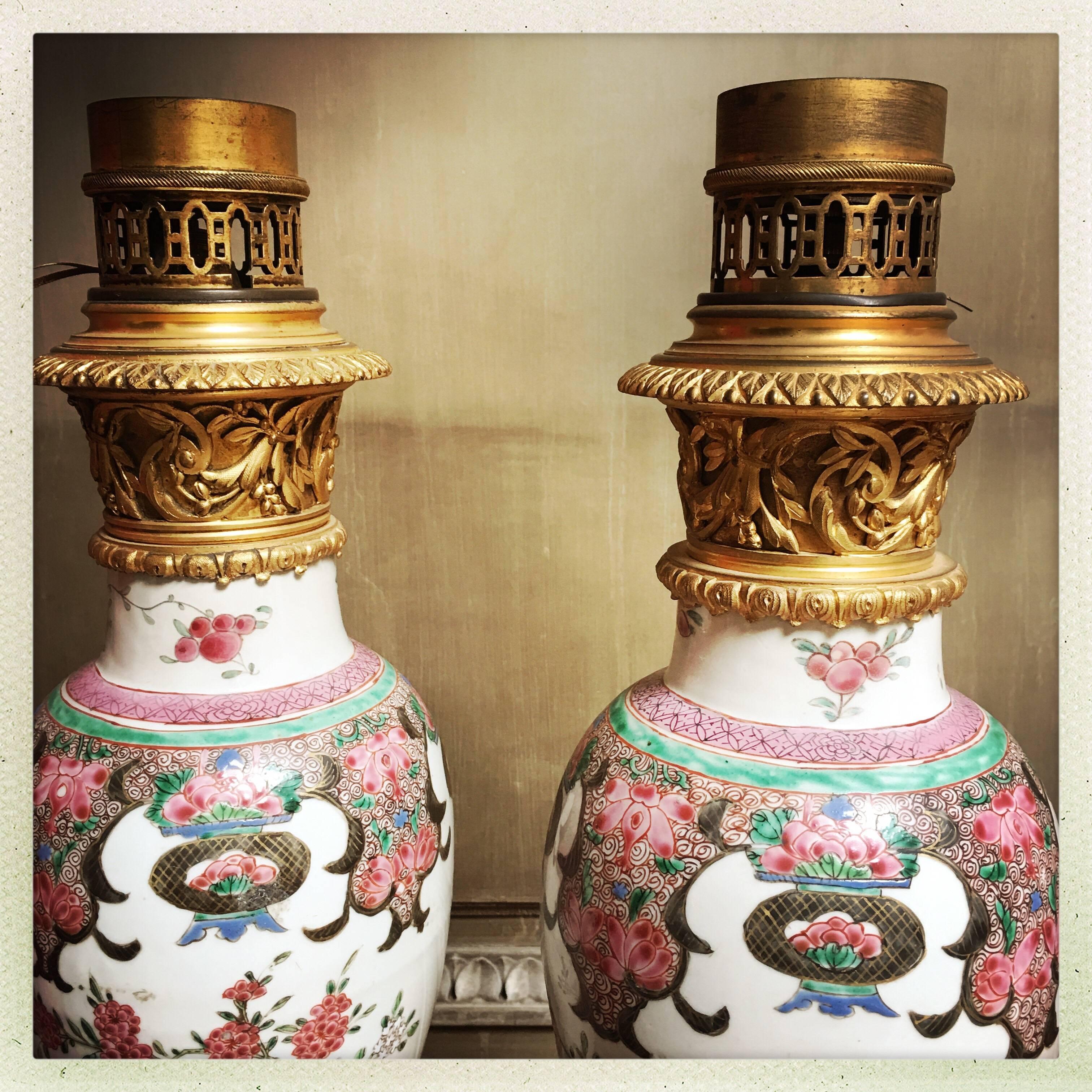 A pair of Chinese Export porcelain lamp bases mounted in French Louis XVI style bronze dore.