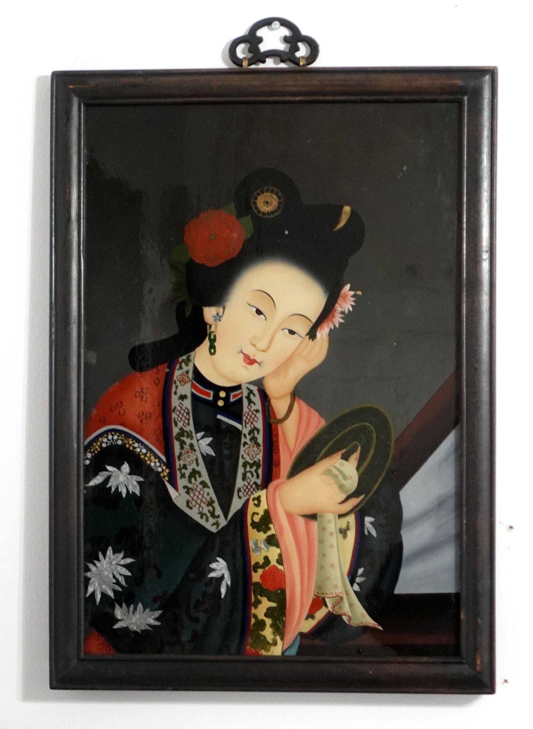 Pair of charming 19th-century Chinese export reverse glass paintings, depicting the beauty of traditional Chinese customs and clothing decorations on the noblewomen.  The paintings come with their original hardwood frame and the old pins in the back