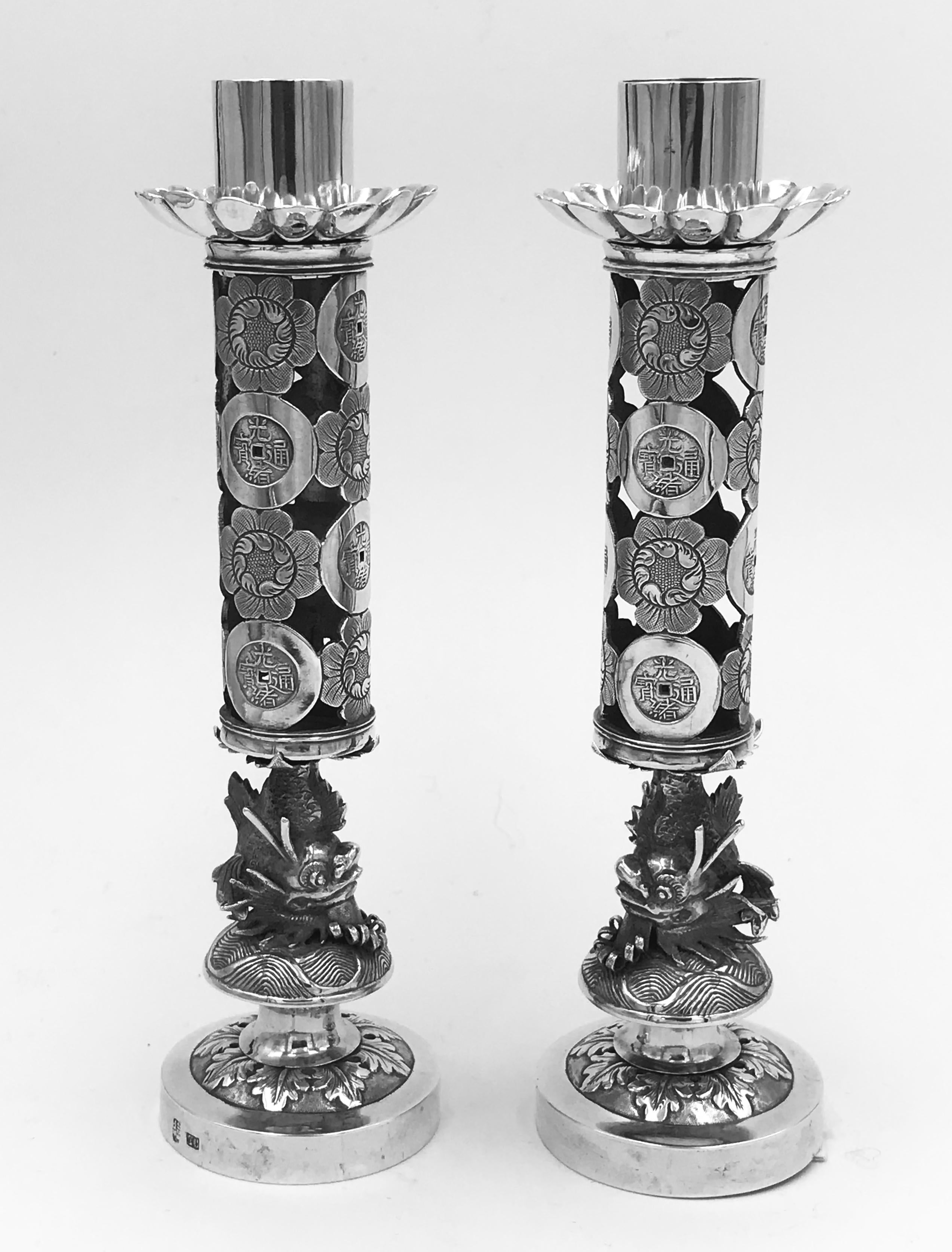A pair of Chinese Export silver candlesticks, marked with TC, for Tuck Chang, 德祥 公记(DeXiangGongJi), a Shanghai retailer from 1901-1934, and with the maker's mark of 培记 (PeiJi).
230gms
Size: Height 158mm
Diameter of base 43mm.