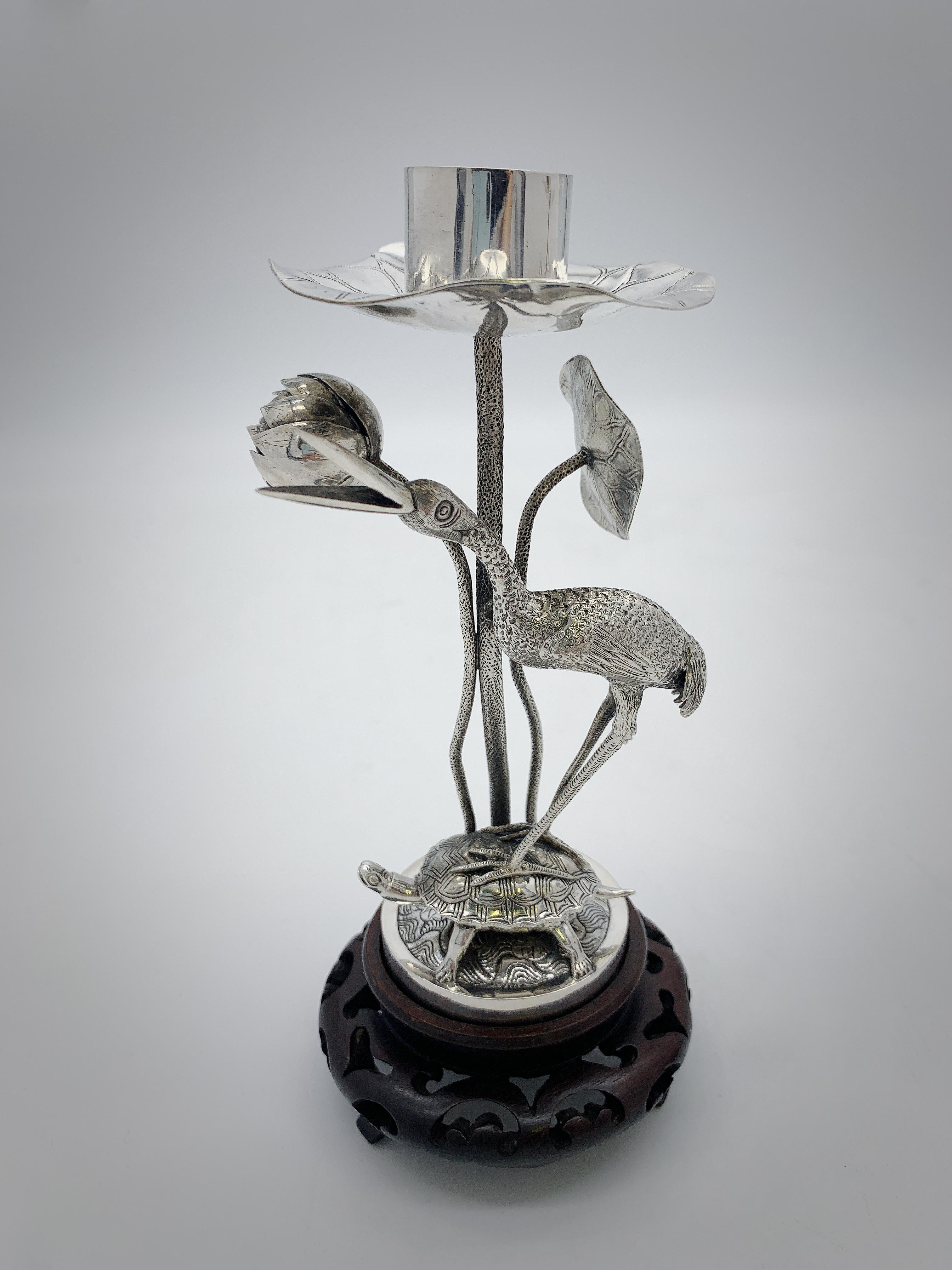 A pair of Chinese export silver candlesticks each depicting crane on a tortoise. Crane and tortoise are the symbol of immortality, happiness and longevity in Chinese mythology. The crane also used as a symbol of high position of power and life full