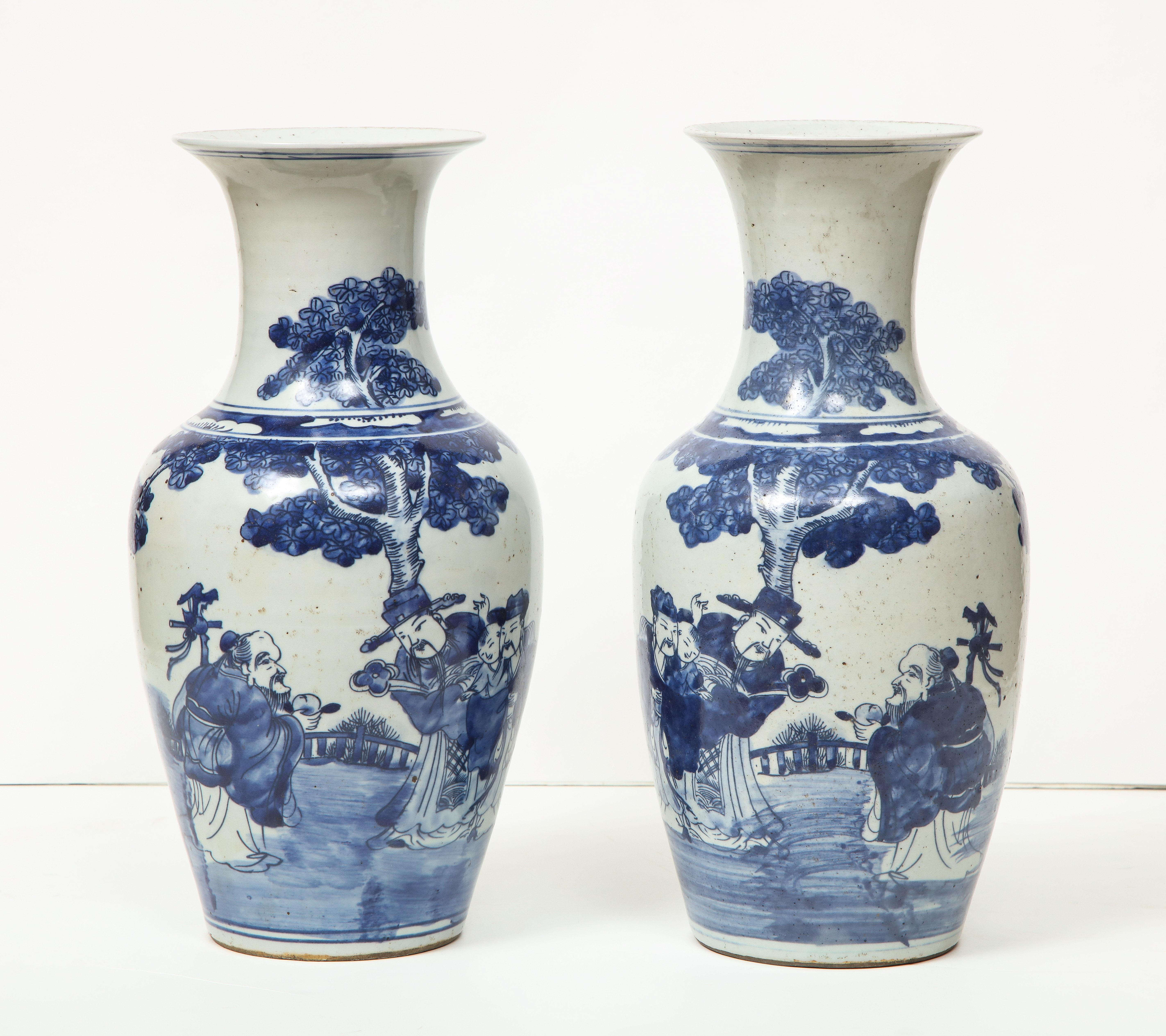 A pair of lovely Chinese export porcelain vases with a bottle neck. This pair have a timeless quality about them. They are the perfect accent pieces in a room and would look great on a mantle or as a centerpiece.