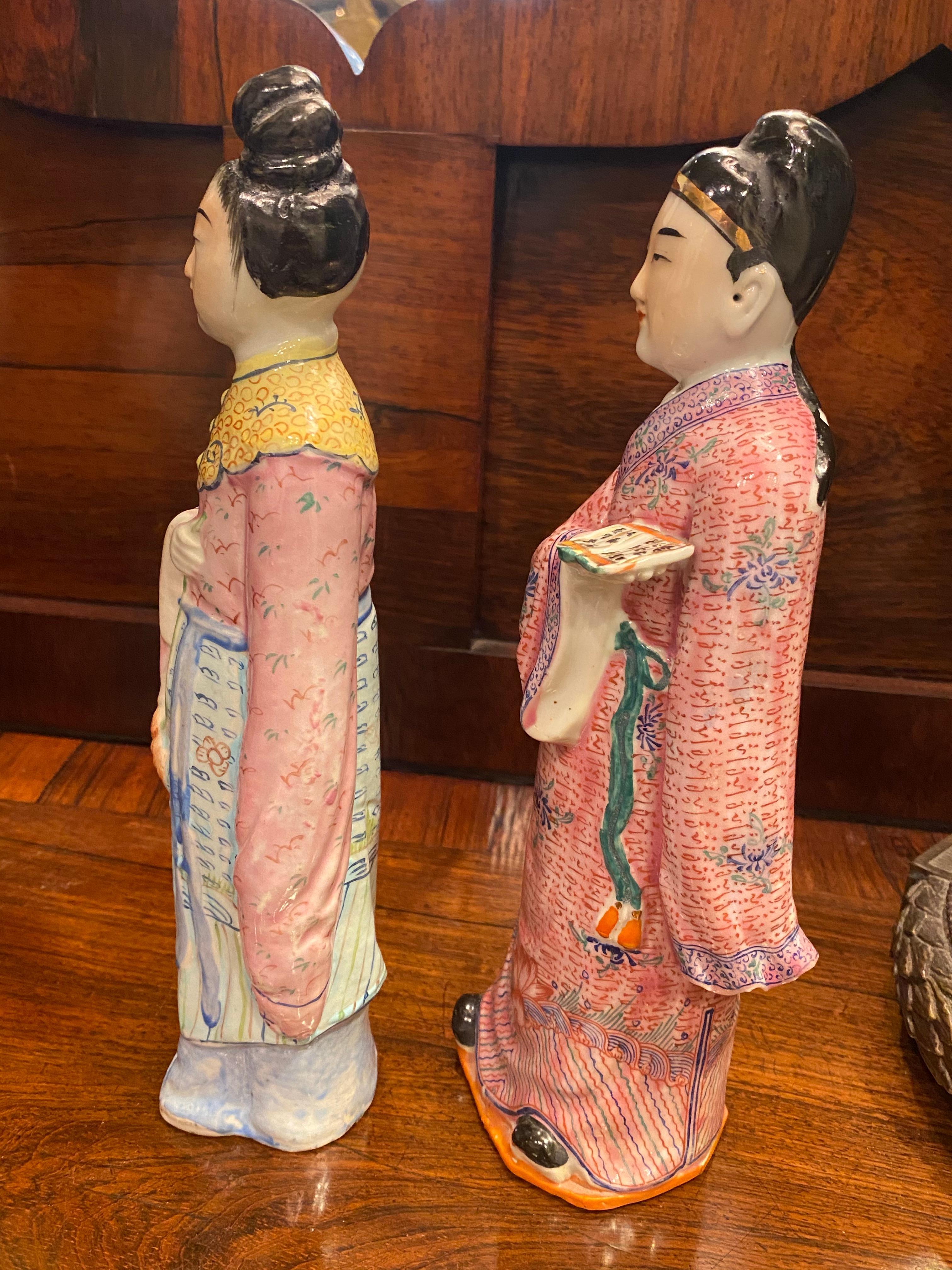 A wonderful pair of Chinese porcelain statues hand painted in enamel with heavy detail in the design of the robes, the faces are painted well. She is marked and do not see a mark on him but they are a pair.