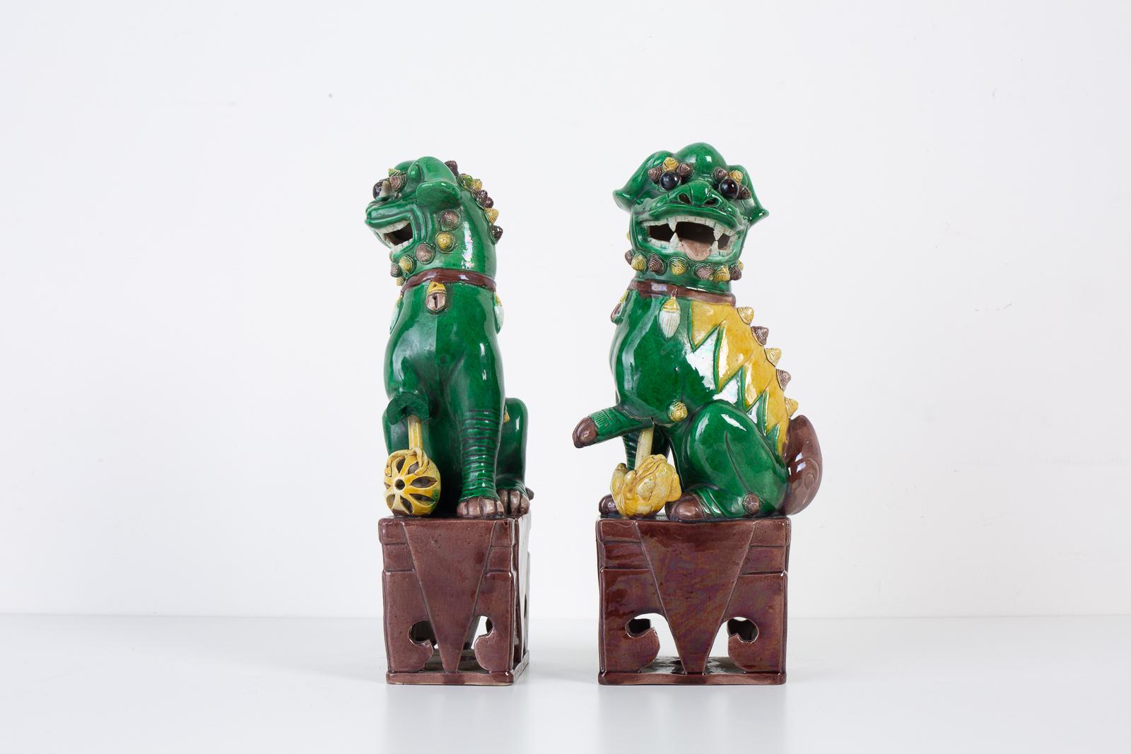 Ceramic Pair of Chinese Famille Verte Foo Dogs on Stands For Sale