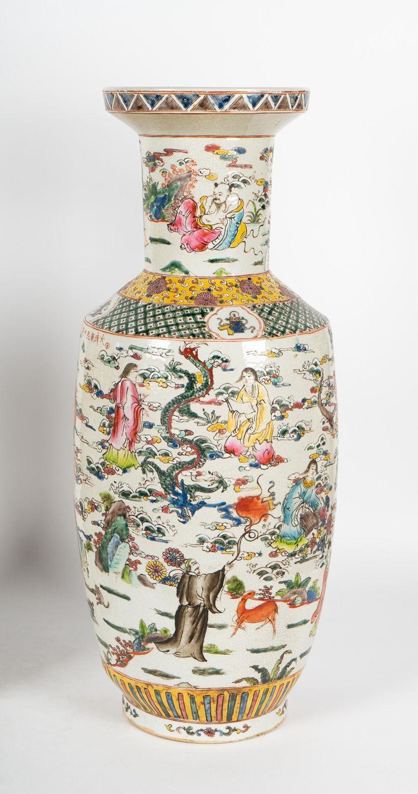 A pair of beautiful Famille Verte vases made in China in the 1900's, finely hand-painted all around with depictions such as people with traditional attire, animals, botanical figures, etc. The vibrant yellow and green tones really make these vases