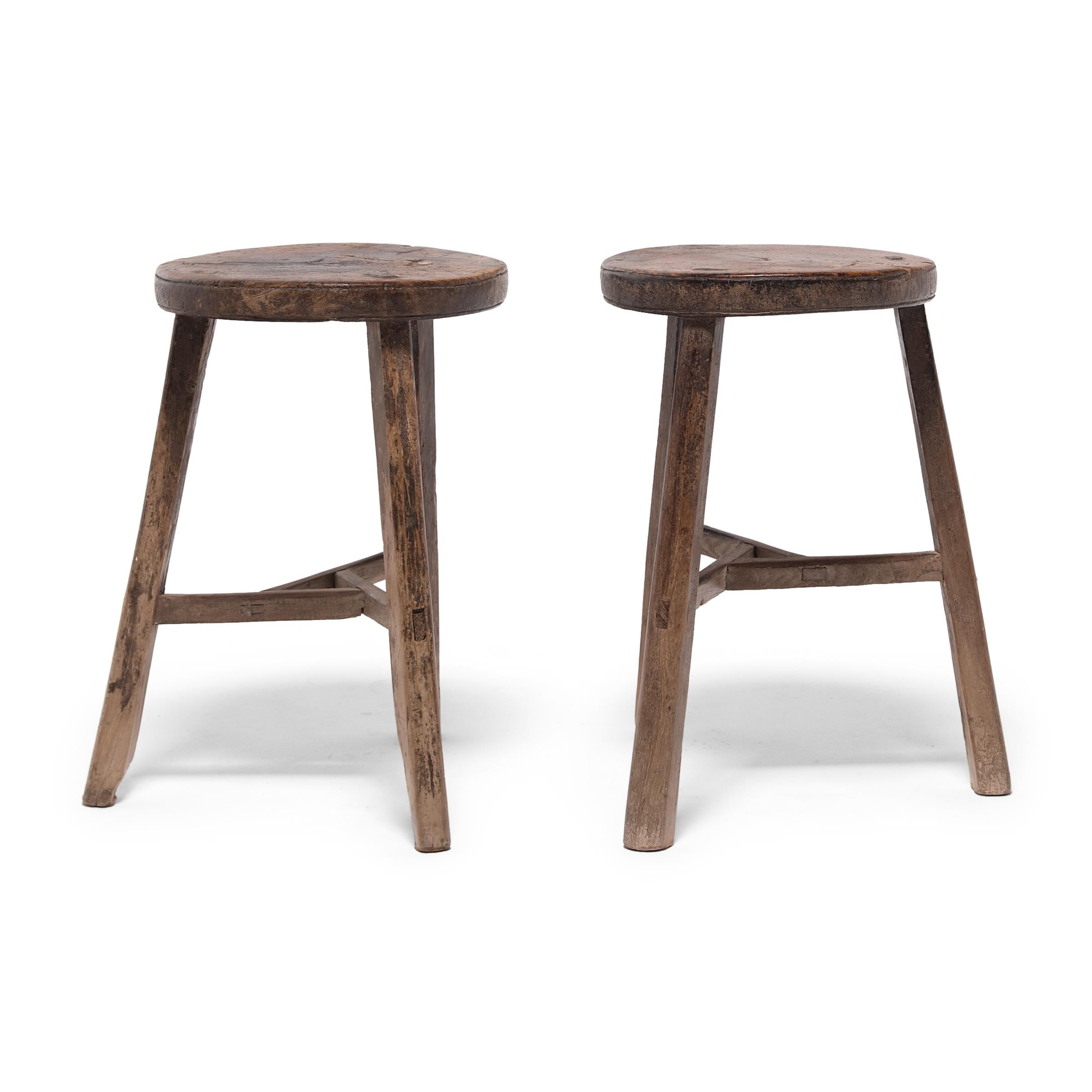 Deceptively simple, these early 20th century stools from Hebei province show off the ingenious joinery methods traditionally used by Chinese carpenters. Each stool’s three splayed legs are supported by stretcher bars that interlock at the center to