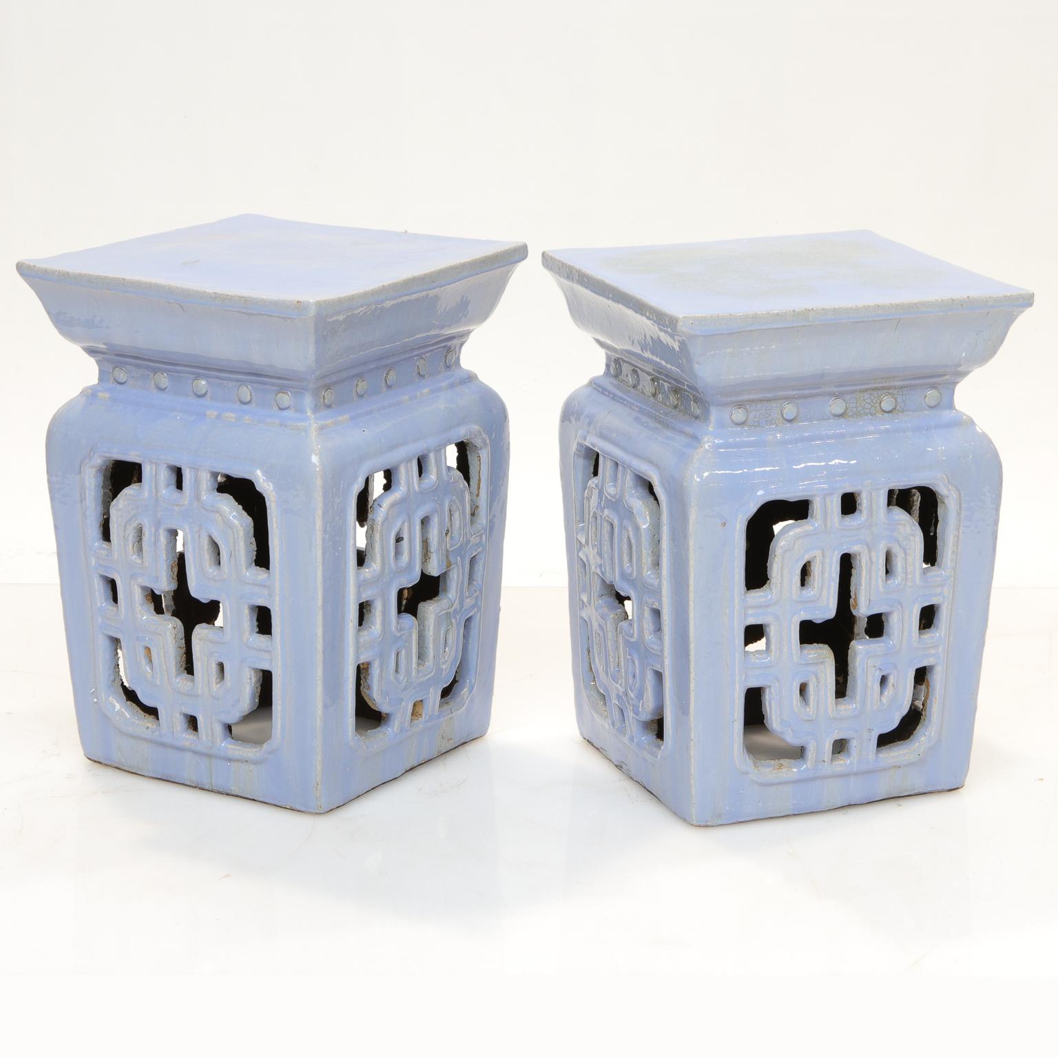 A pair of ceramic Chinese garden seats with pierced design (usually patterned after designs of shutters). Square tops. A great color blue, soft and striking color. Very good condition. Almost a periwinkle blue/purple. Cool color!