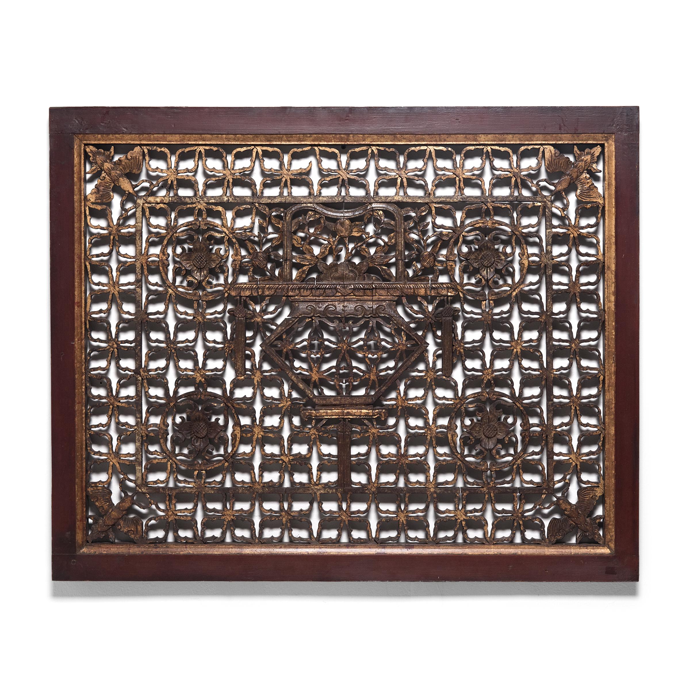 Decorated with oxblood-red lacquer and their original gold paint, this pair of ornate window panels is a beautiful example of traditional Chinese latticework. Set into a wall or door, lattice windows such as these allowed light and air into a room