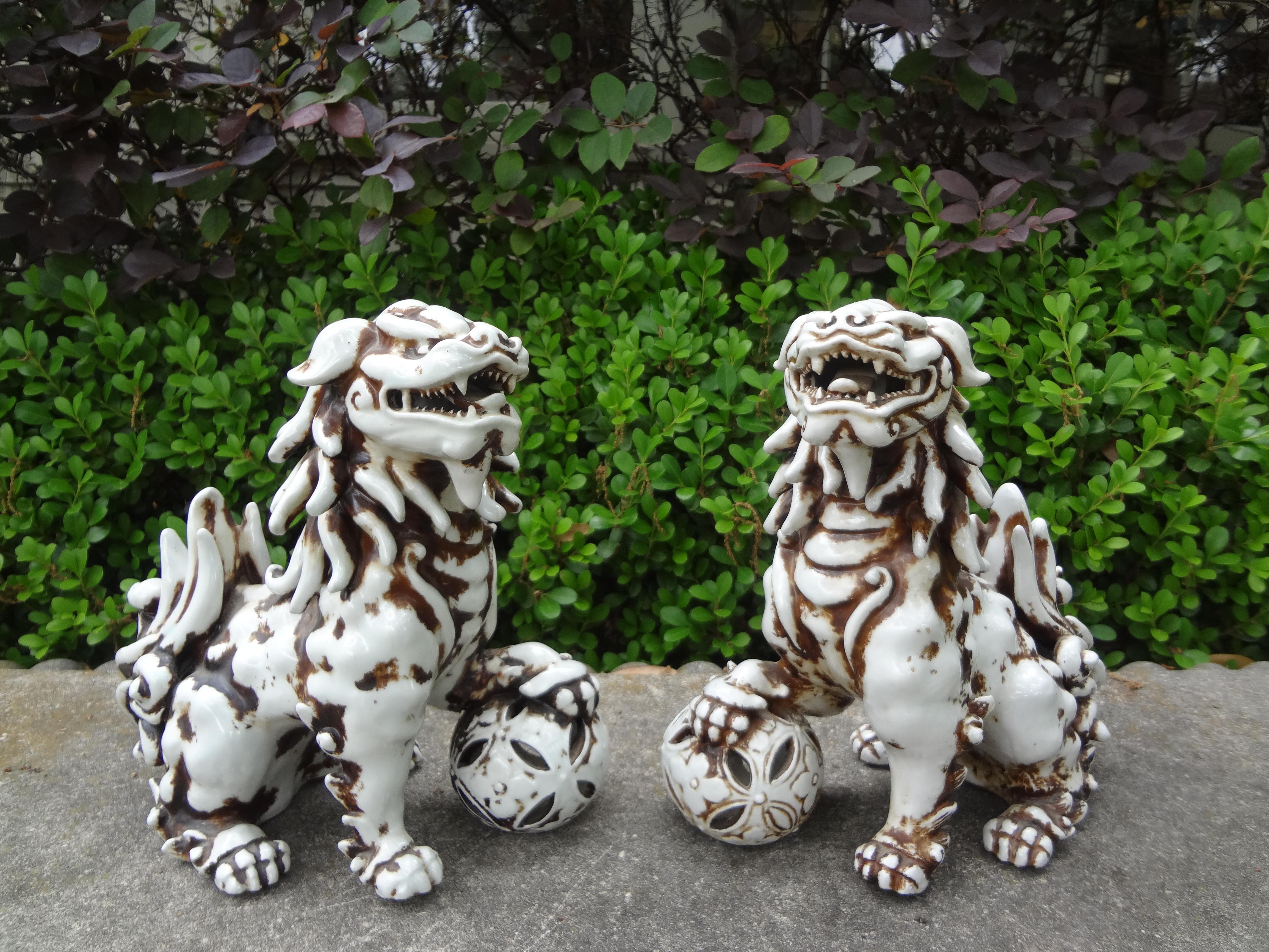 Pair Of Chinese Glazed Ceramic Foo Dogs.
This unusual pair of Chinese export glazed ceramic foo dogs are of cream and black
color with illegible markings.
Great pair!