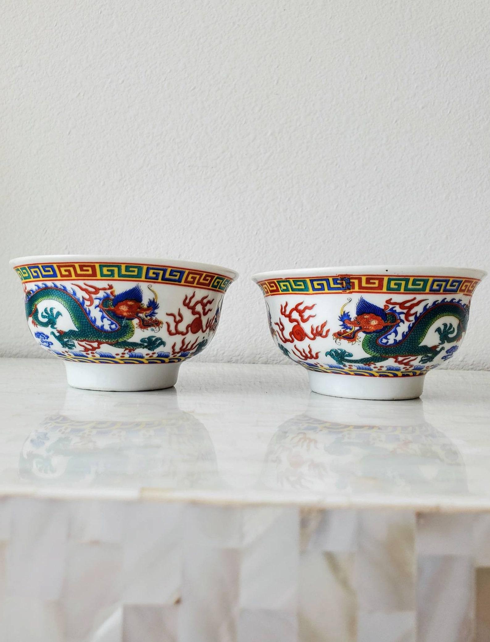 A wonderful pair of vintage Chinese footed bead bowls. Believed to be from the first half of the 20th century, this Wucai five-colored double-dragon play bead bowl has a deep abdomen, and a rounded foot. Signed, underfoot marked over glaze six