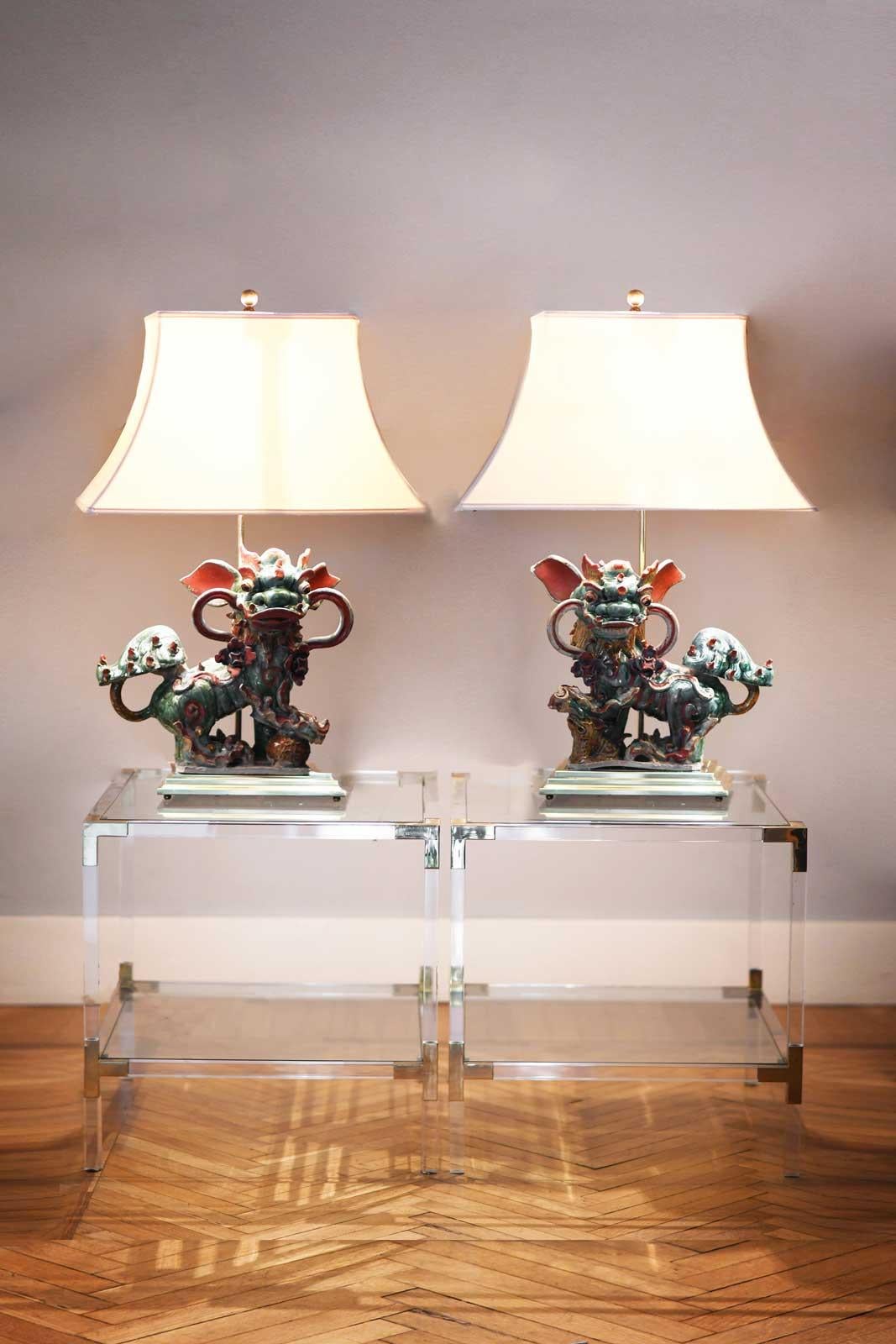 Pair of Chinese Glazed Stoneware Buddhist Lions Lamp on a brass base come from Villa Giuseppina, one of the most representative residences on Lake Como. Built in the third decade of the 20th century for the English Garwood family. In the 90s with