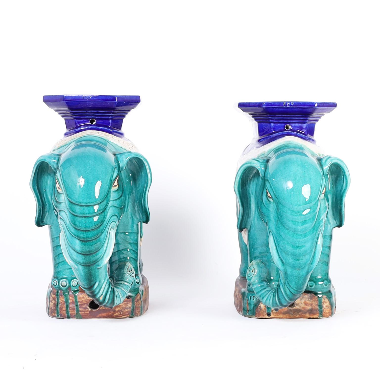 Mid-century Chinese elephant seats or stools crafted in terra cotta, and decorated with a drip glaze technique in striking traditional colors.