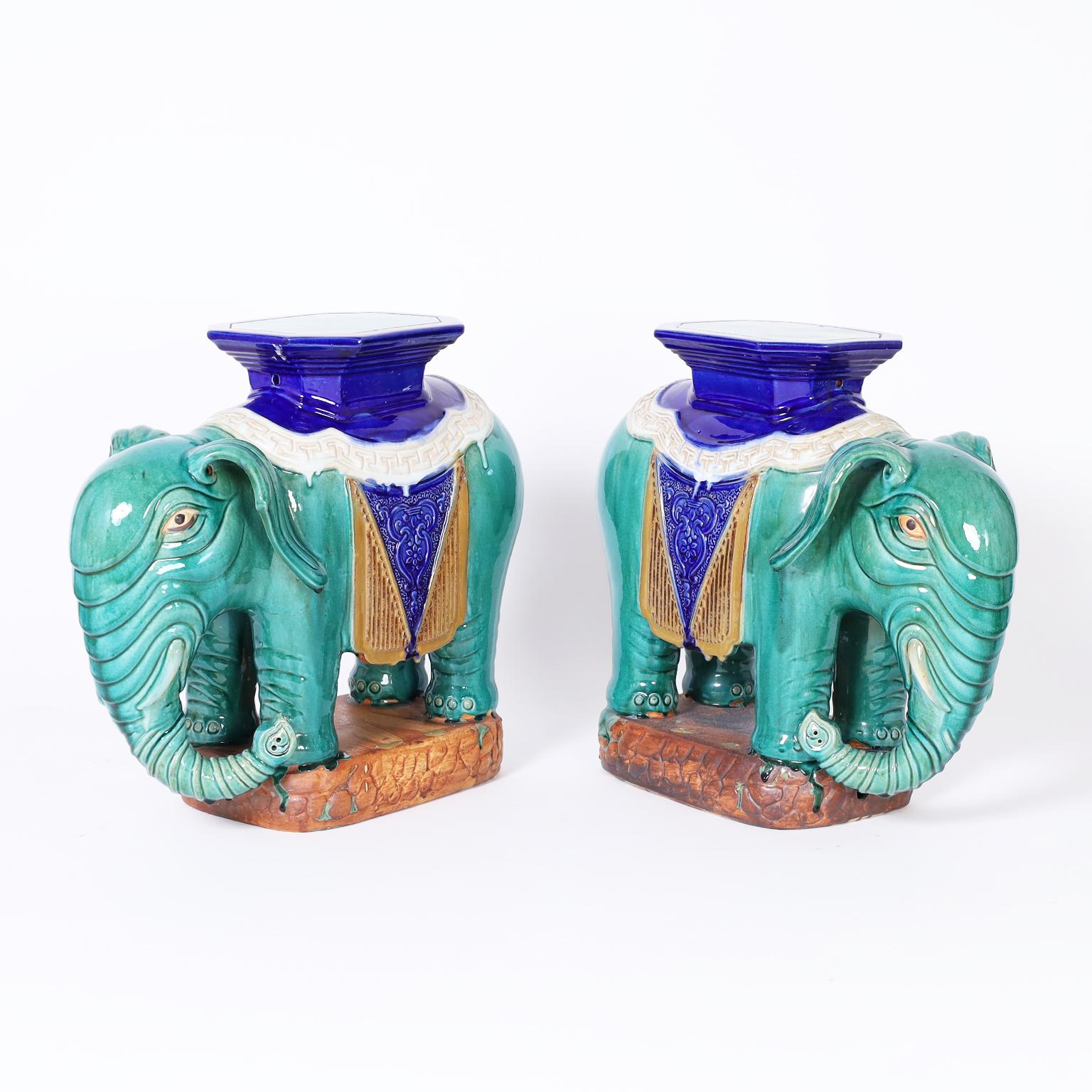 Pair of mid-century Chinese elephant garden seats or stools crafted in terra cotta and decorated with a drip glaze technique in striking traditional colors.