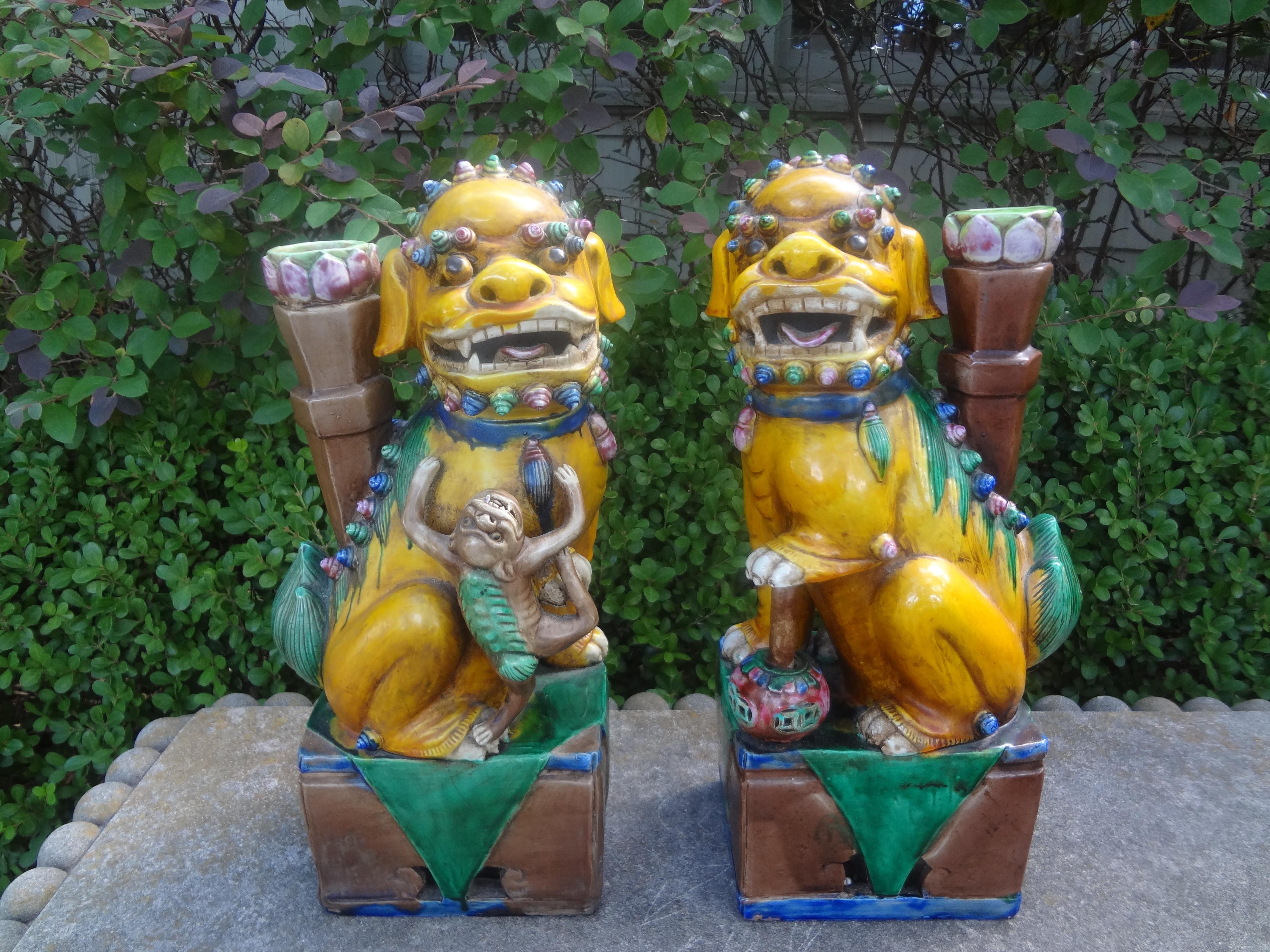 Pair of Chinese Glazed Terracotta Foo Dogs or Foo Lions.
Stunning antique Chinese foo dogs or foo lions which date to the 1920's. This unusual pair of Chinese export foo dogs with exquisite detailing were executed in beautiful colors and feature a