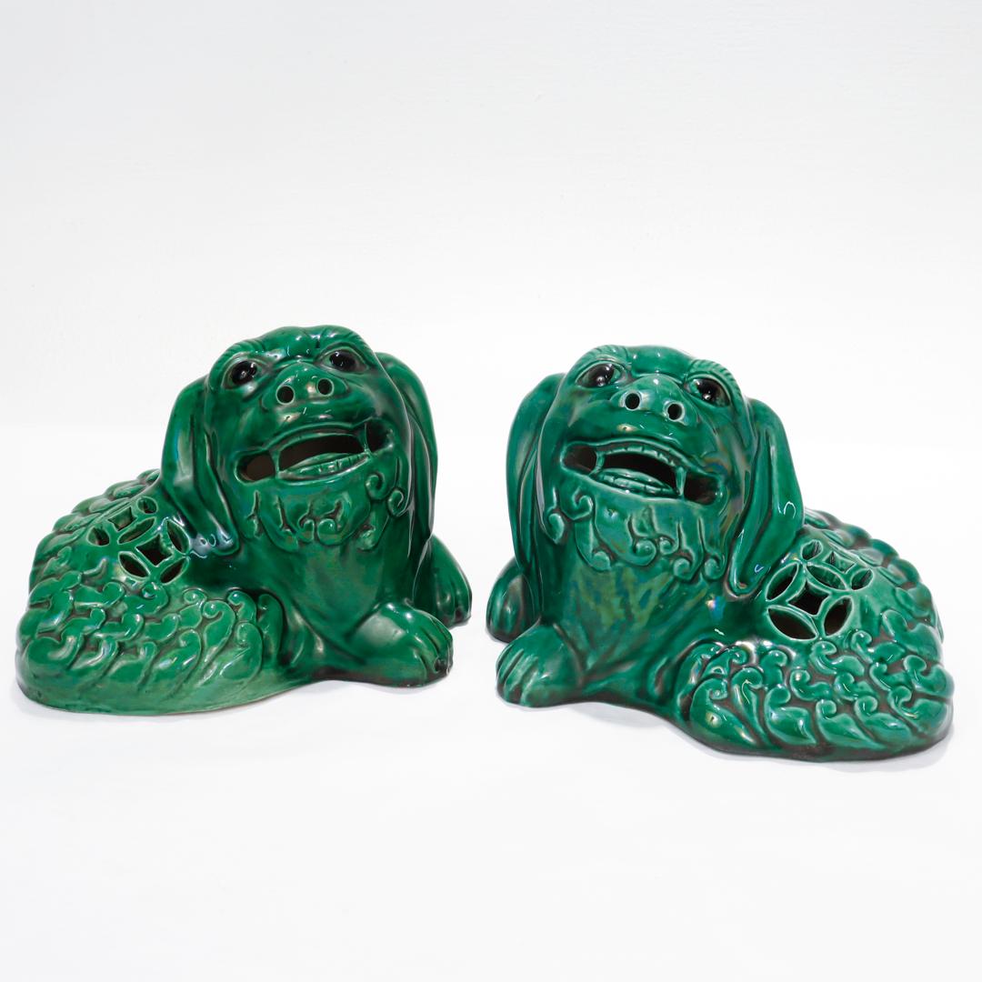 A fine pair of Chinese foo dog figurines.

In a green, glazed pottery.

Depicting complementary recumbent foo dogs with slightly raised heads and upward gazes.

Simply a wonderful pair of Chinese foo dogs!

Date:
20th Century

Overall
