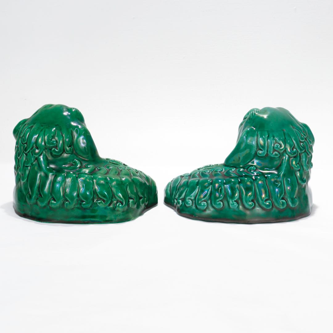 Chinese Export Pair of Chinese Green Glazed Pottery Recumbent Foo Dog Figurines For Sale