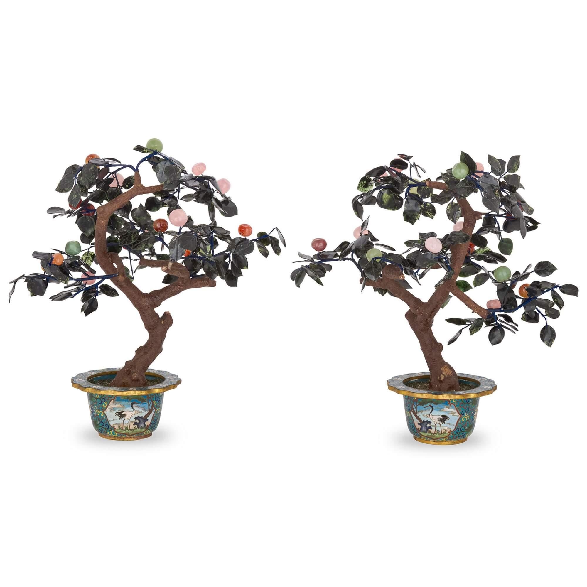 Pair of Chinese hardstone and cloisonné enamel flower models
Chinese, 20th Century 
Height 52cm, width 46cm, depth 36cm

These two superb flower models are almost identical in design. Each comprises a metal tree decorated with hardstone leaves and