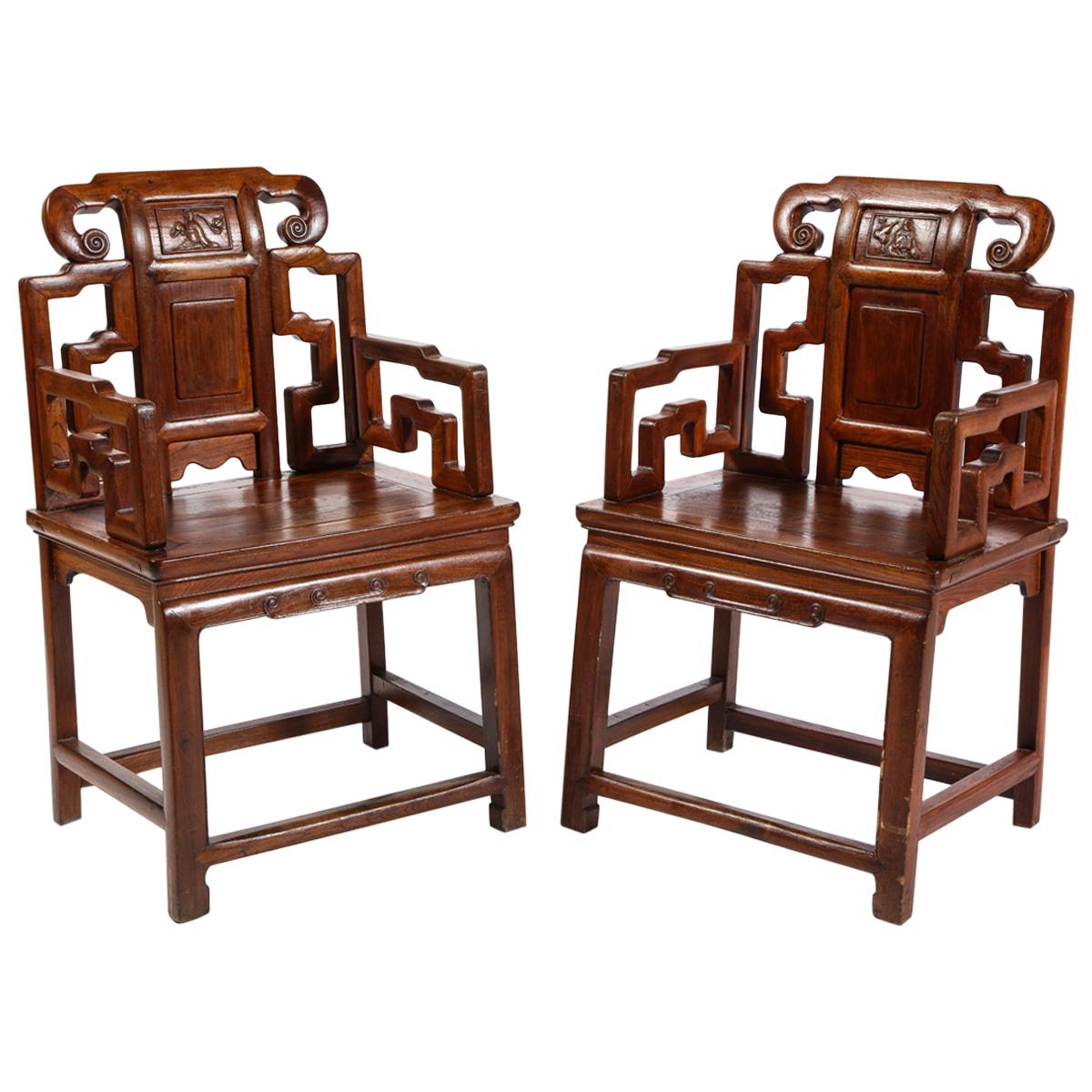 Pair of Chinese Hardwood Chairs with Fretwork Designs and High Relief Panels For Sale